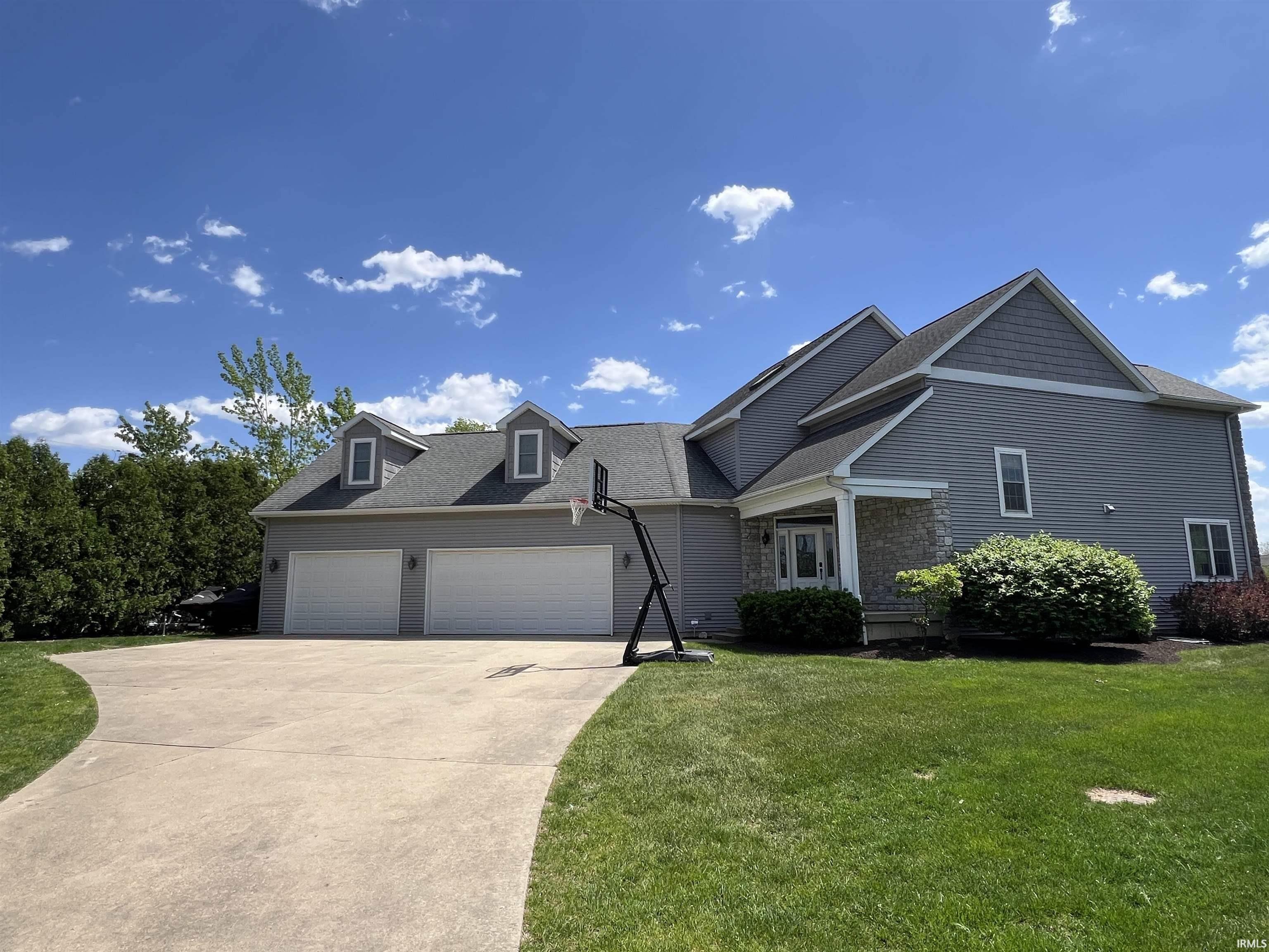 Image 3: View of front of property with an attached garage, concrete driveway, roof with shingles, and a front yard, Front Of Structure