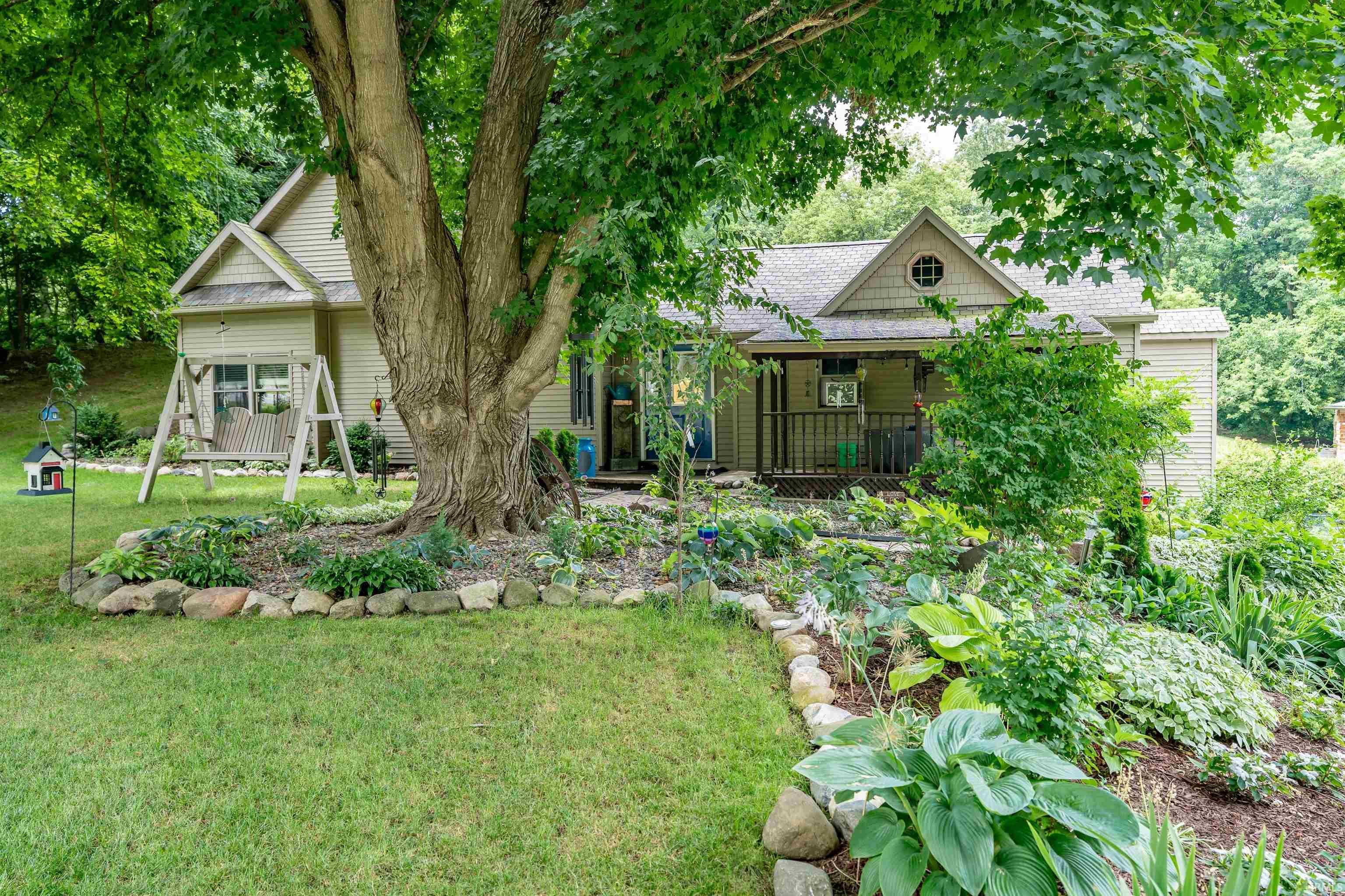 Image 0: View of front of home with a shingled roof, covered porch, and a front yard, Front Of Structure Image 0: View of front of home with a shingled roof, covered porch, and a front yard, Front Of Structure