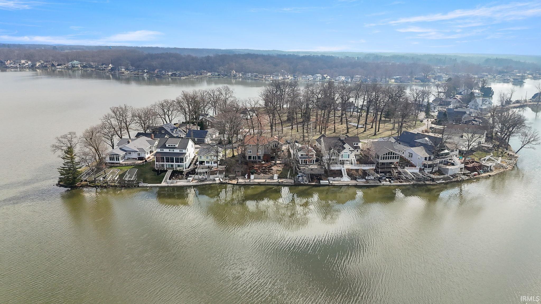 Image 0: Aerial perspective of suburban area with a large body of water, Aerial View Image 0: Aerial perspective of suburban area with a large body of water, Aerial View