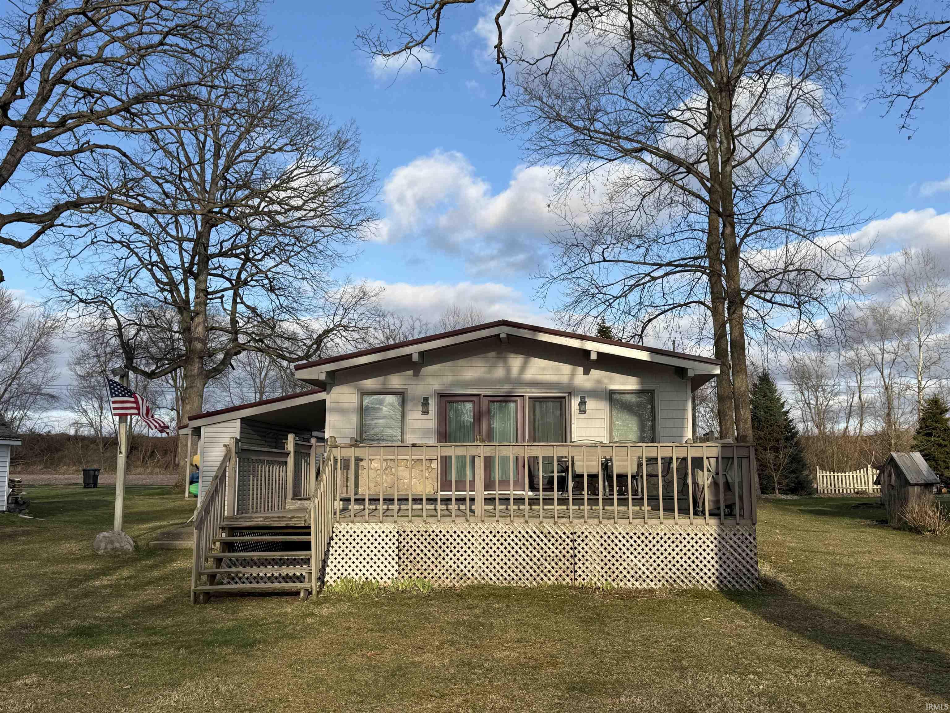 Image 1: Front of house featuring a yard and a deck (Lakeside), Front of Structure Image 1: Front of house featuring a yard and a deck (Lakeside), Front of Structure