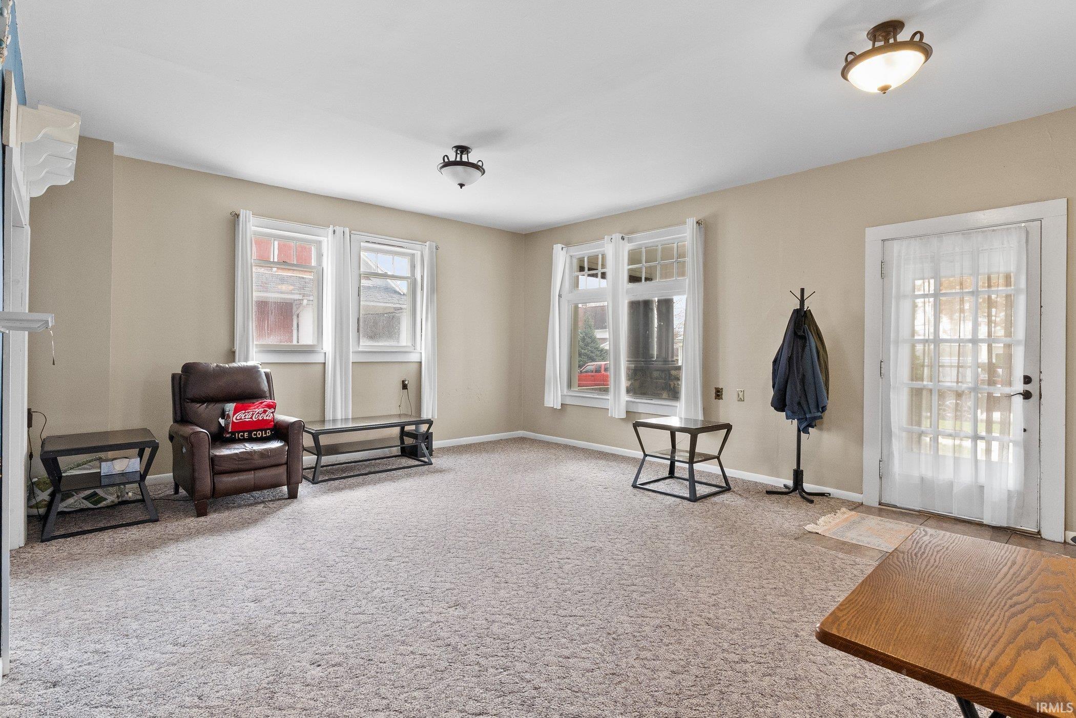 Image 2: Living area with light carpet and baseboards, Sitting Room