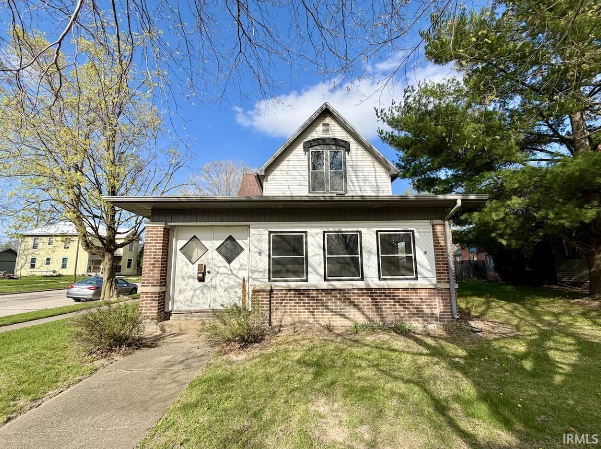 Image 0: View of front of house featuring brick siding and a front yard, Front Of Structure