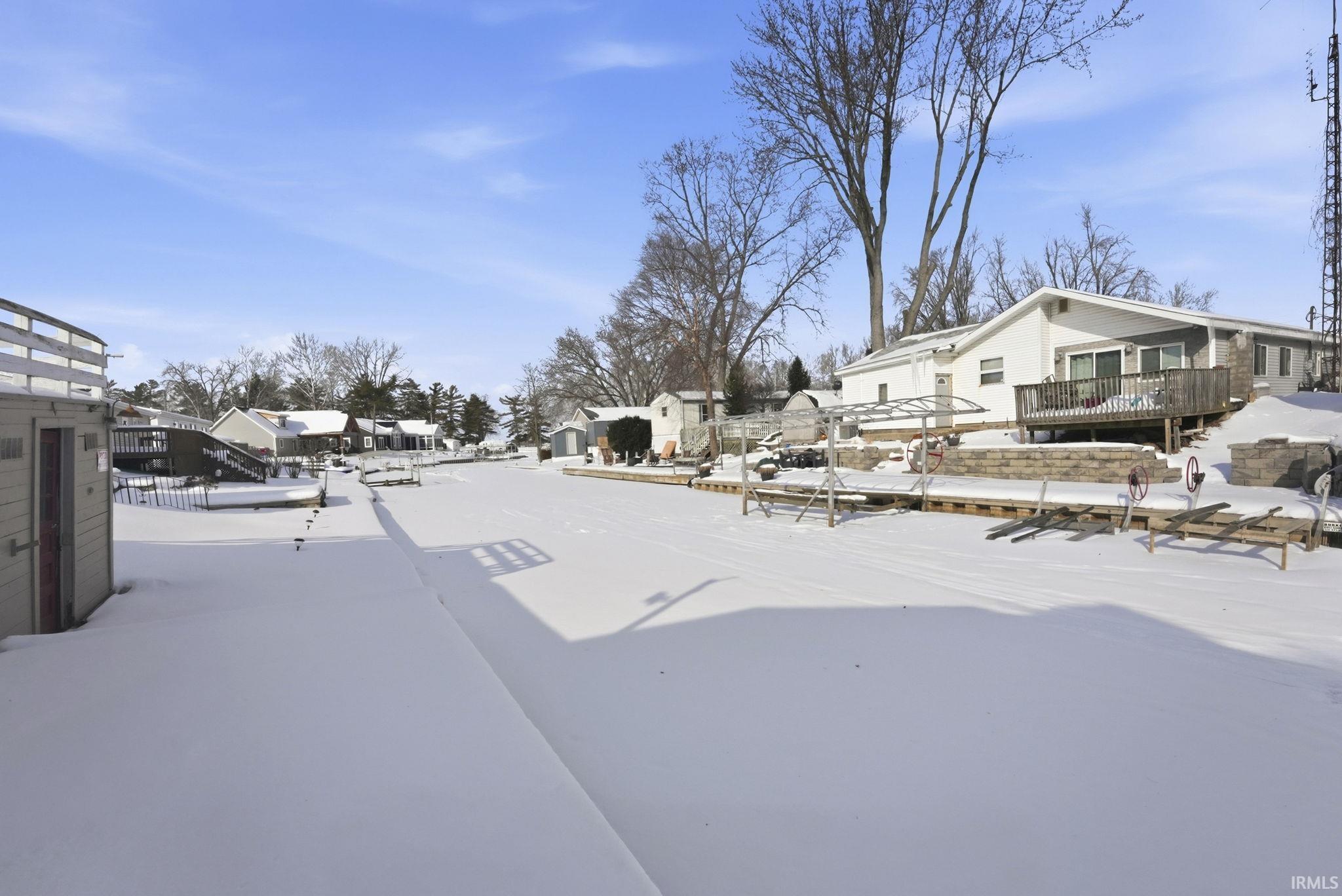 Image 3: Yard layered in snow with a residential view, Yard Image 3: Yard layered in snow with a residential view, Yard