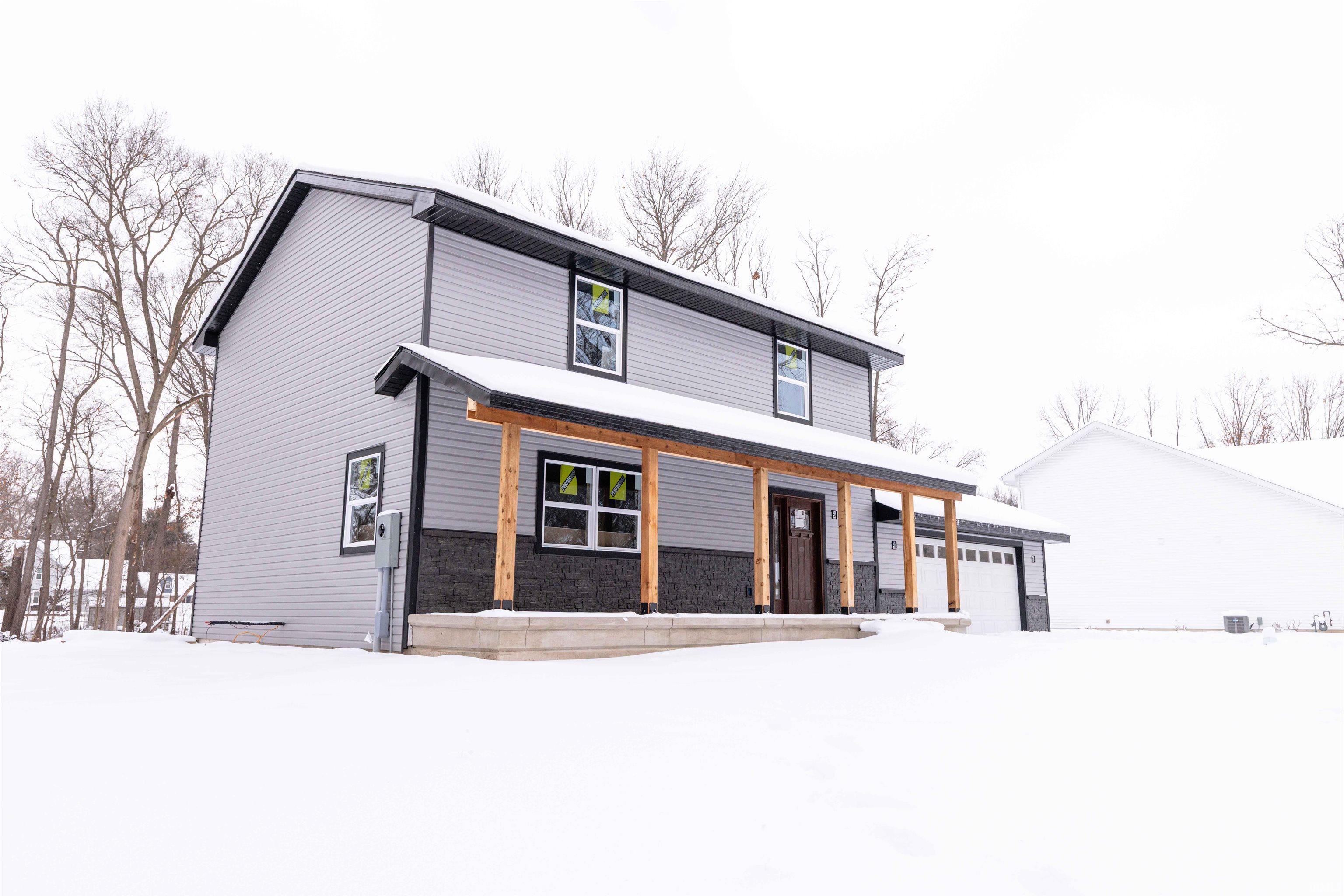 Image 2: Modern farmhouse style home with covered porch and a garage, Front Of Structure