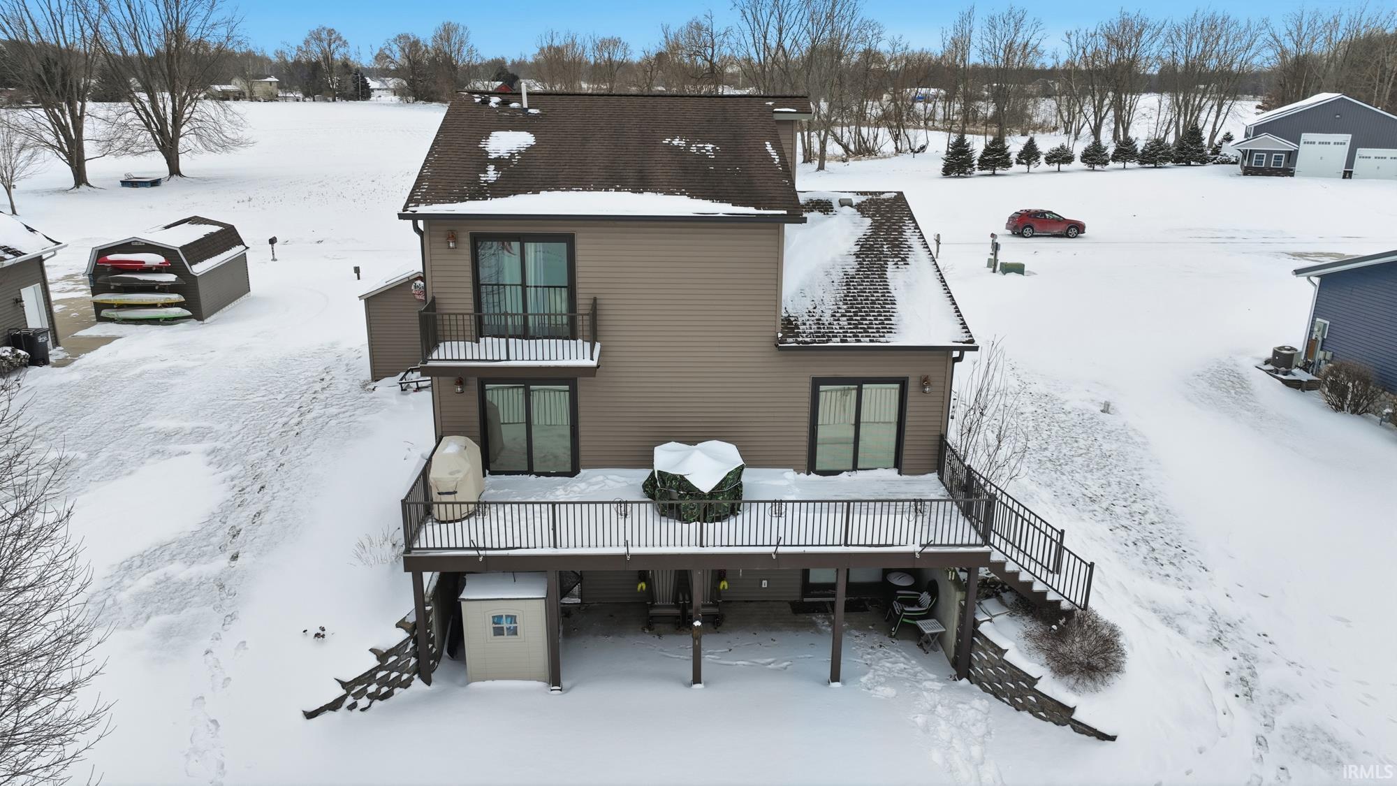 Image 2: Snow covered property with a balcony and a deck, Back Of Structure