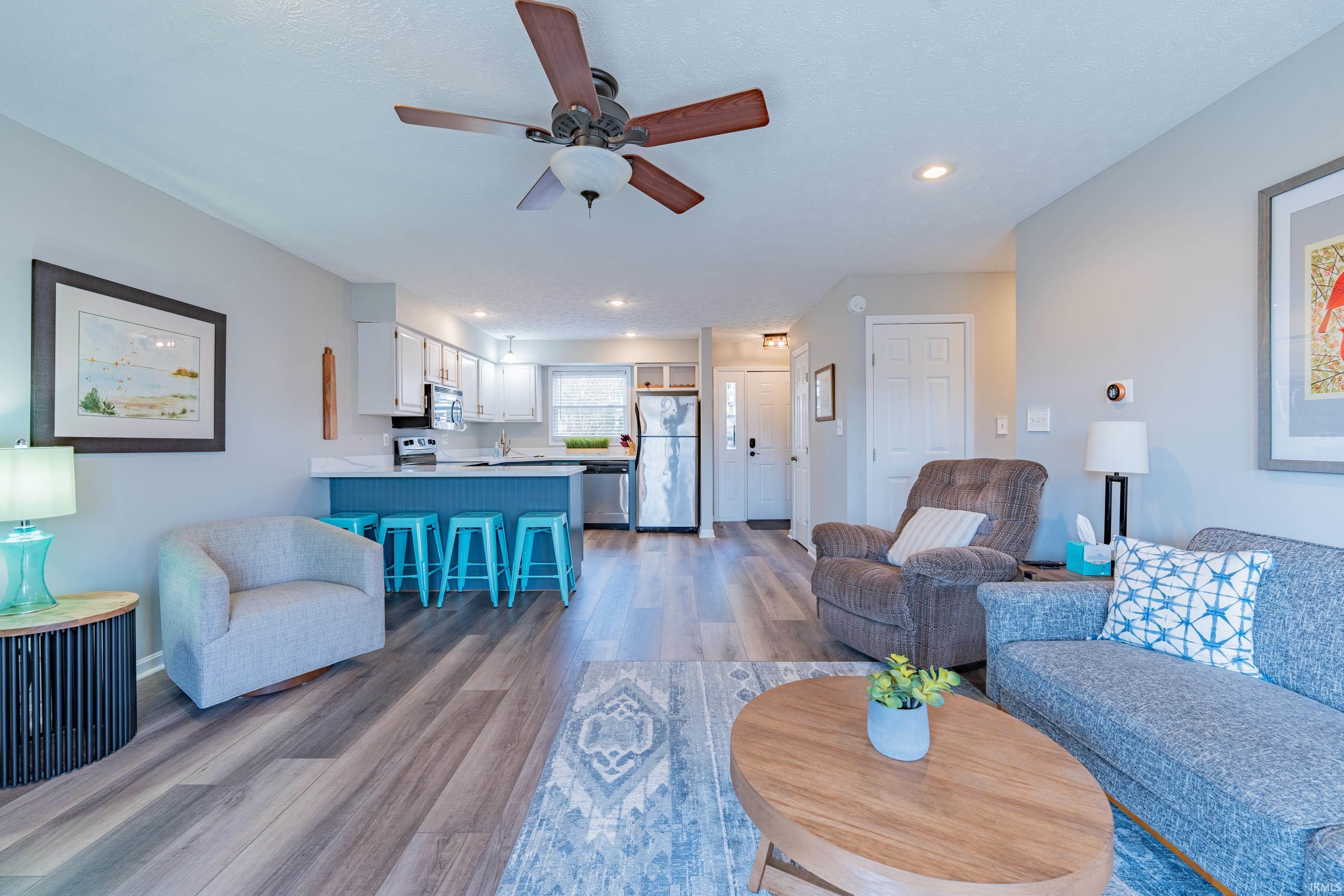 Image 2: Living area with a ceiling fan, dark wood-style floors, and recessed lighting, Living Room Image 2: Living area with a ceiling fan, dark wood-style floors, and recessed lighting, Living Room