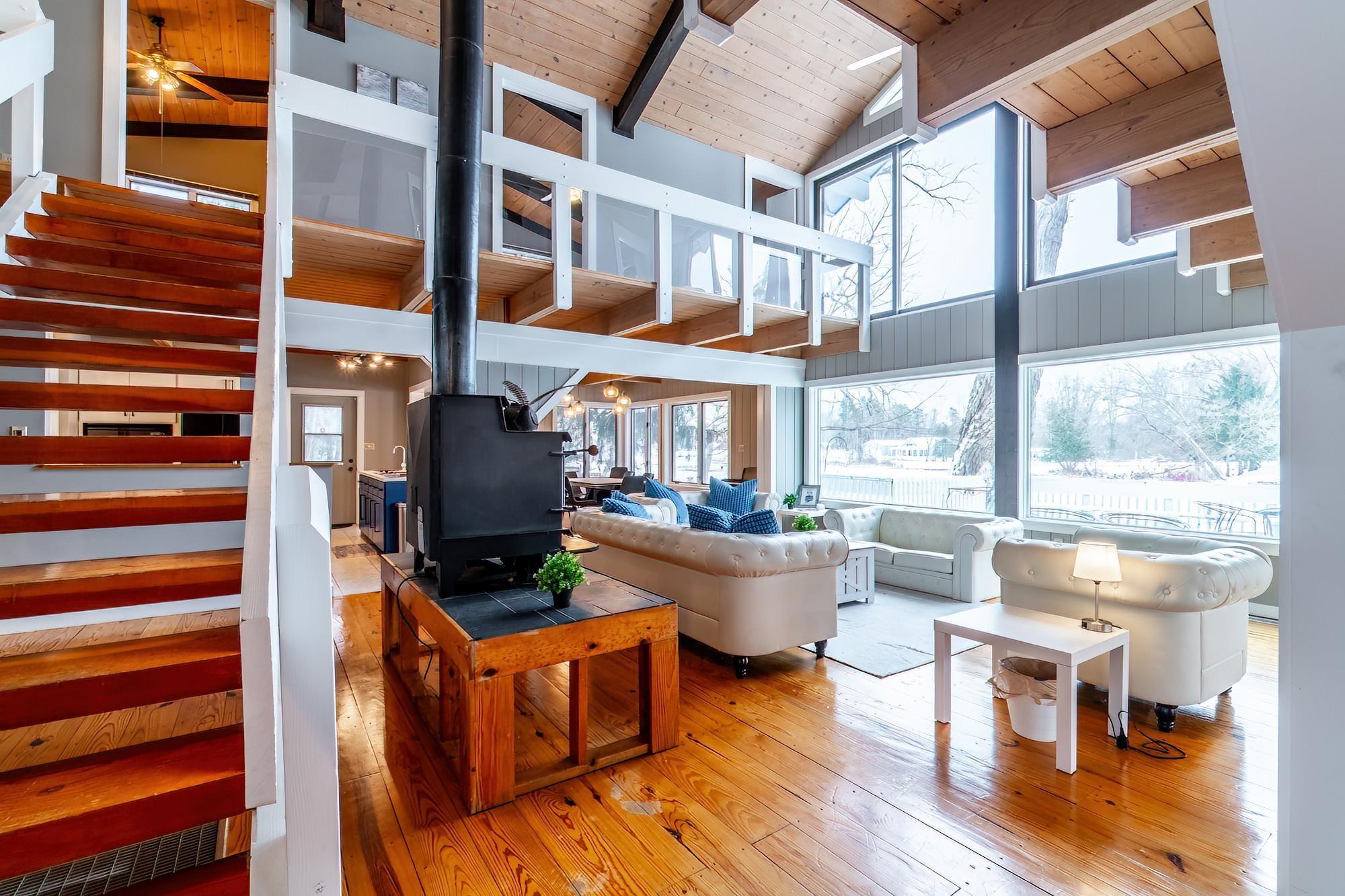 Image 1: 4685 W Nevada Mills Road, Angola, IN 46703, Natural light and lake views through oversized windows.