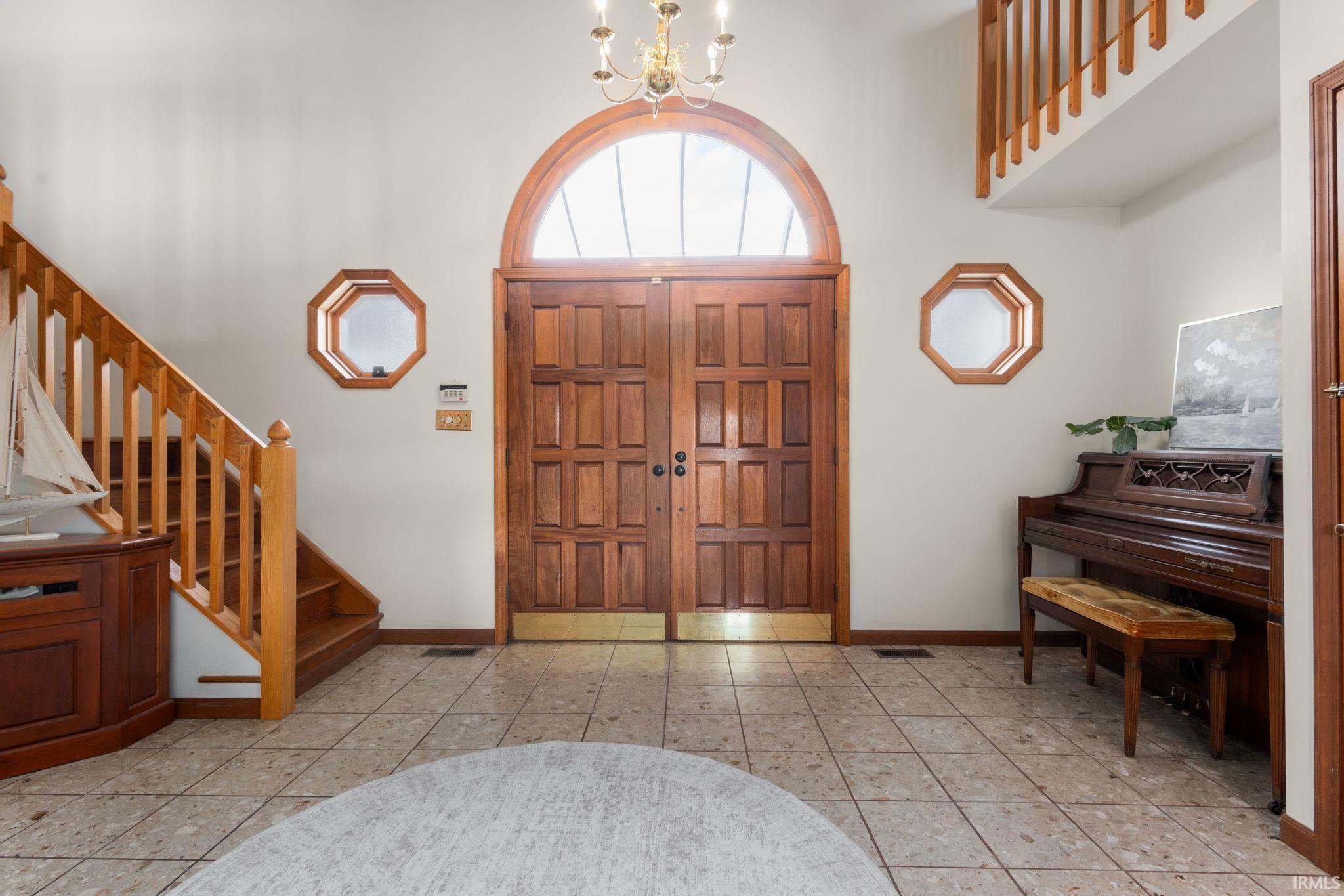 Image 2: Entrance foyer featuring suspended lighting, a high ceiling, and light tile patterned flooring, Entrance Foyer Image 2: Entrance foyer featuring suspended lighting, a high ceiling, and light tile patterned flooring, Entrance Foyer