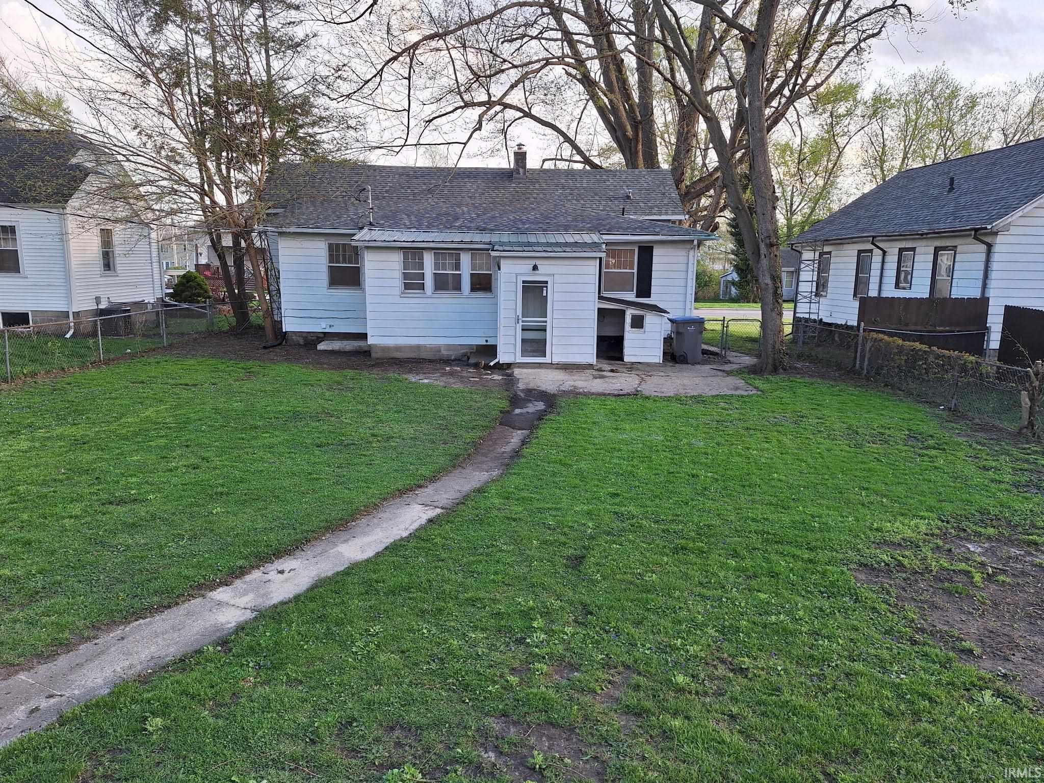 Image 1: Expansive lawn with a concrete walkway leading to the rear entrance, Back Of Structure Image 1: Expansive lawn with a concrete walkway leading to the rear entrance, Back Of Structure