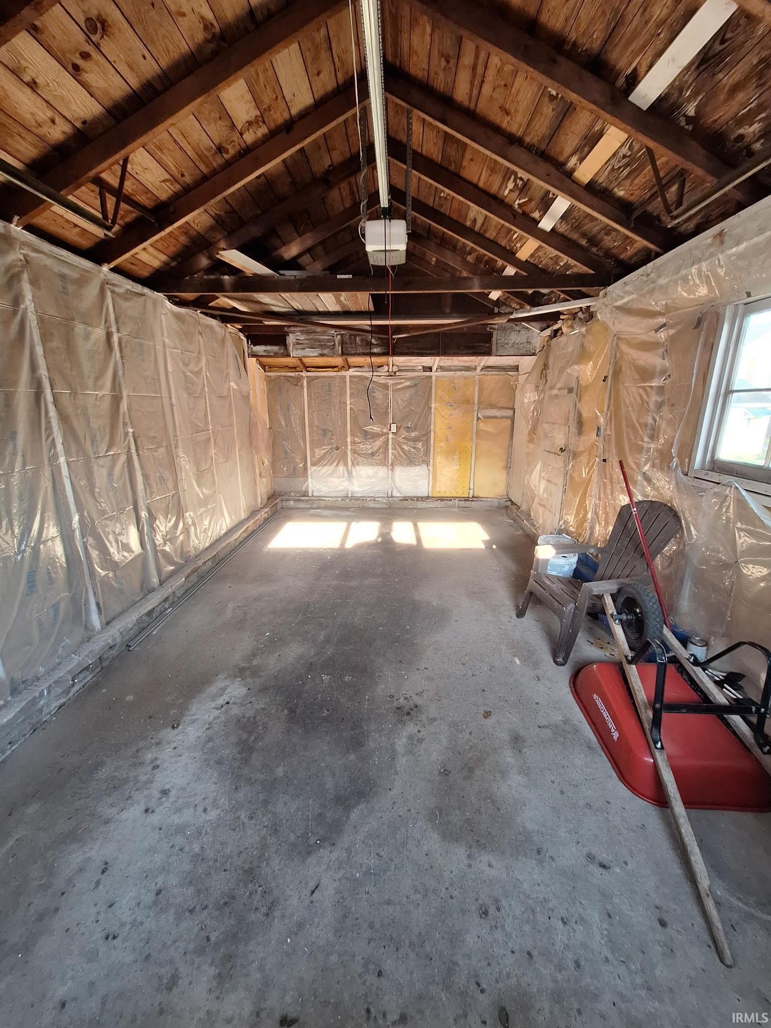 Image 3: Exposed wood beam ceiling in a utilitarian space featuring a concrete floor, framed walls, and a window for natural illumination, Garage Image 3: Exposed wood beam ceiling in a utilitarian space featuring a concrete floor, framed walls, and a window for natural illumination, Garage