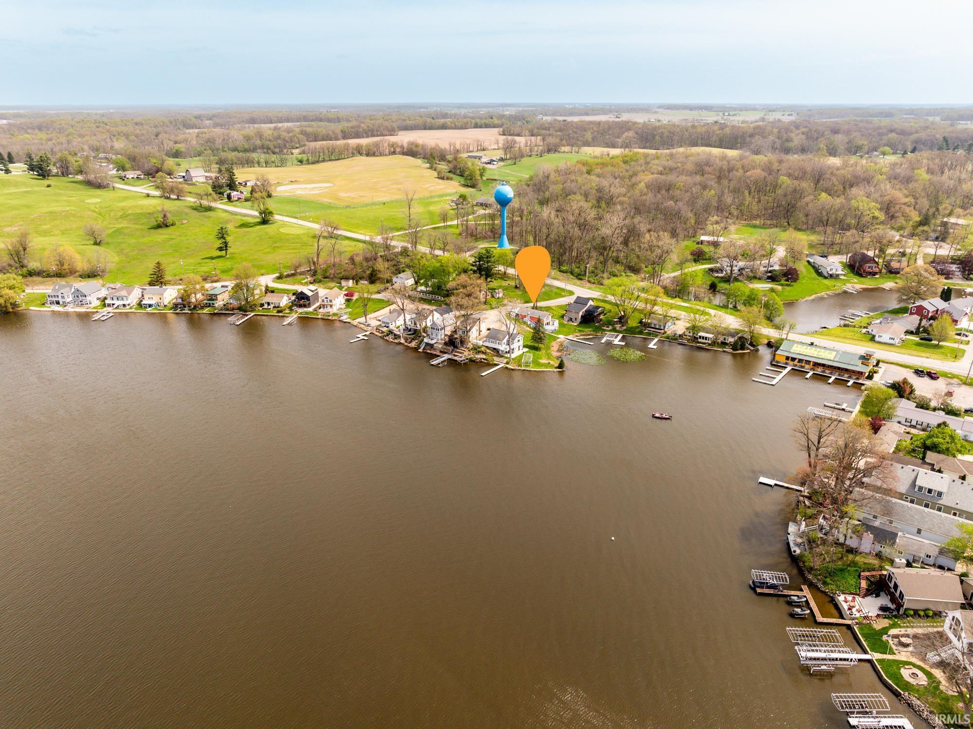 Image 2: Aerial perspective of a lakeside community featuring multiple properties with private docks, Aerial View