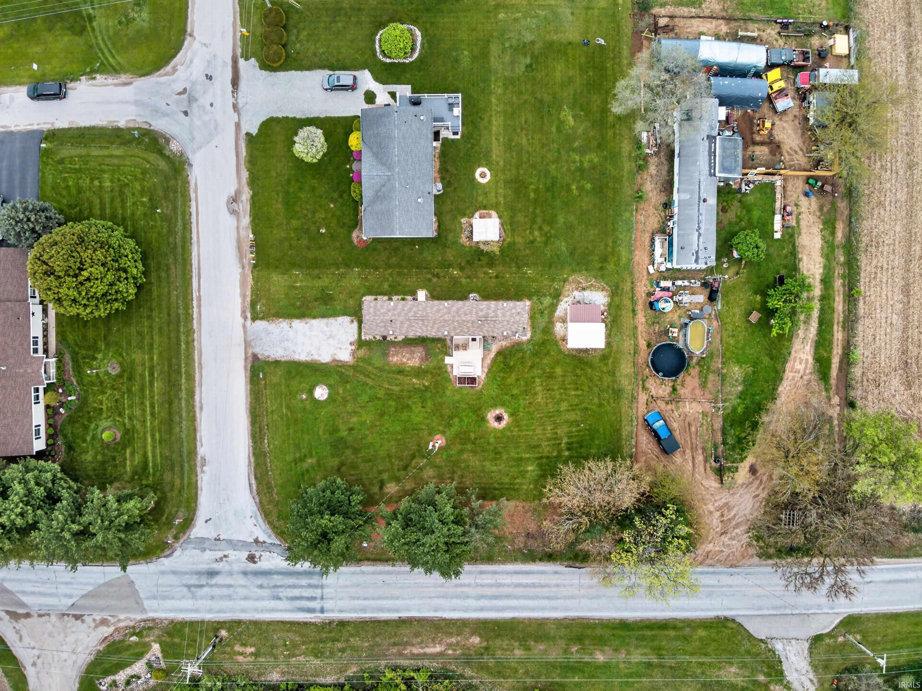 Image 3: Aerial perspective showcasing multiple residential properties with substantial land area, Aerial View