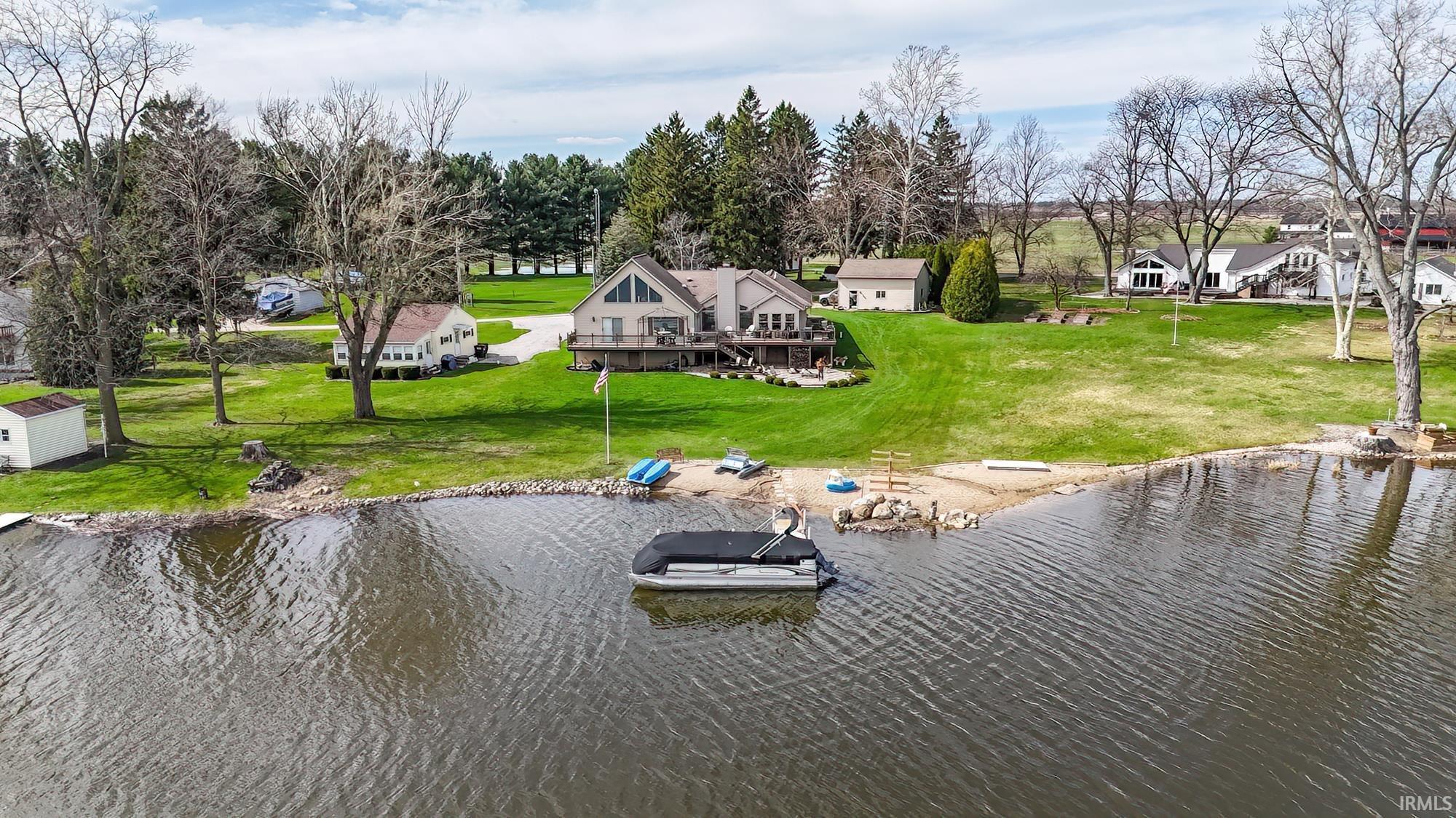 Image 0: 135 ft of Lake front home on .78 acres 4 bedrooms 3 baths Chefs kitchen two story living room with a
