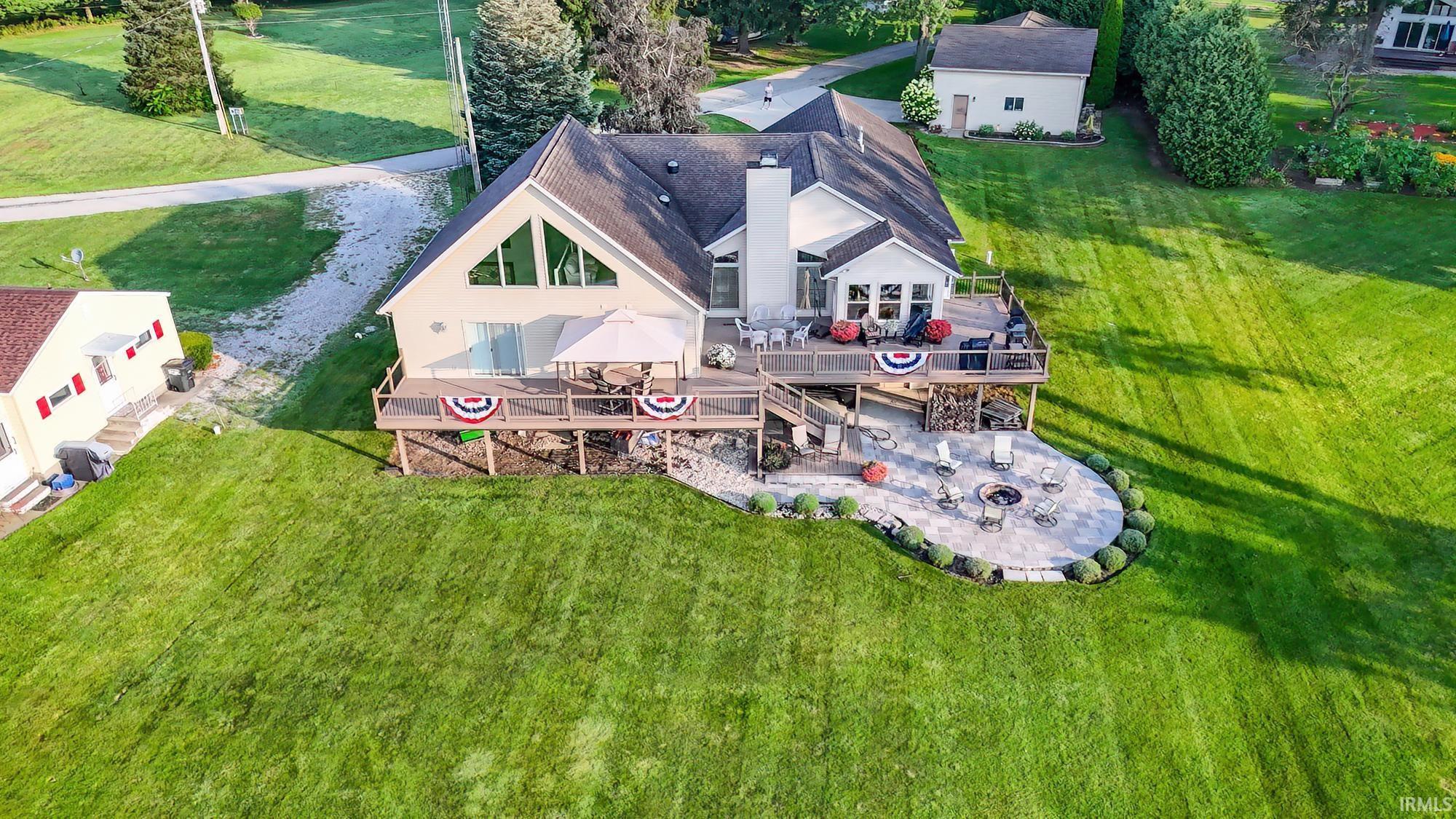 Image 2: Aerial view of property and surrounding area, .78 acre Lakefront Executive home with 26x28 detached 2 story garage with plenty of parking and 135