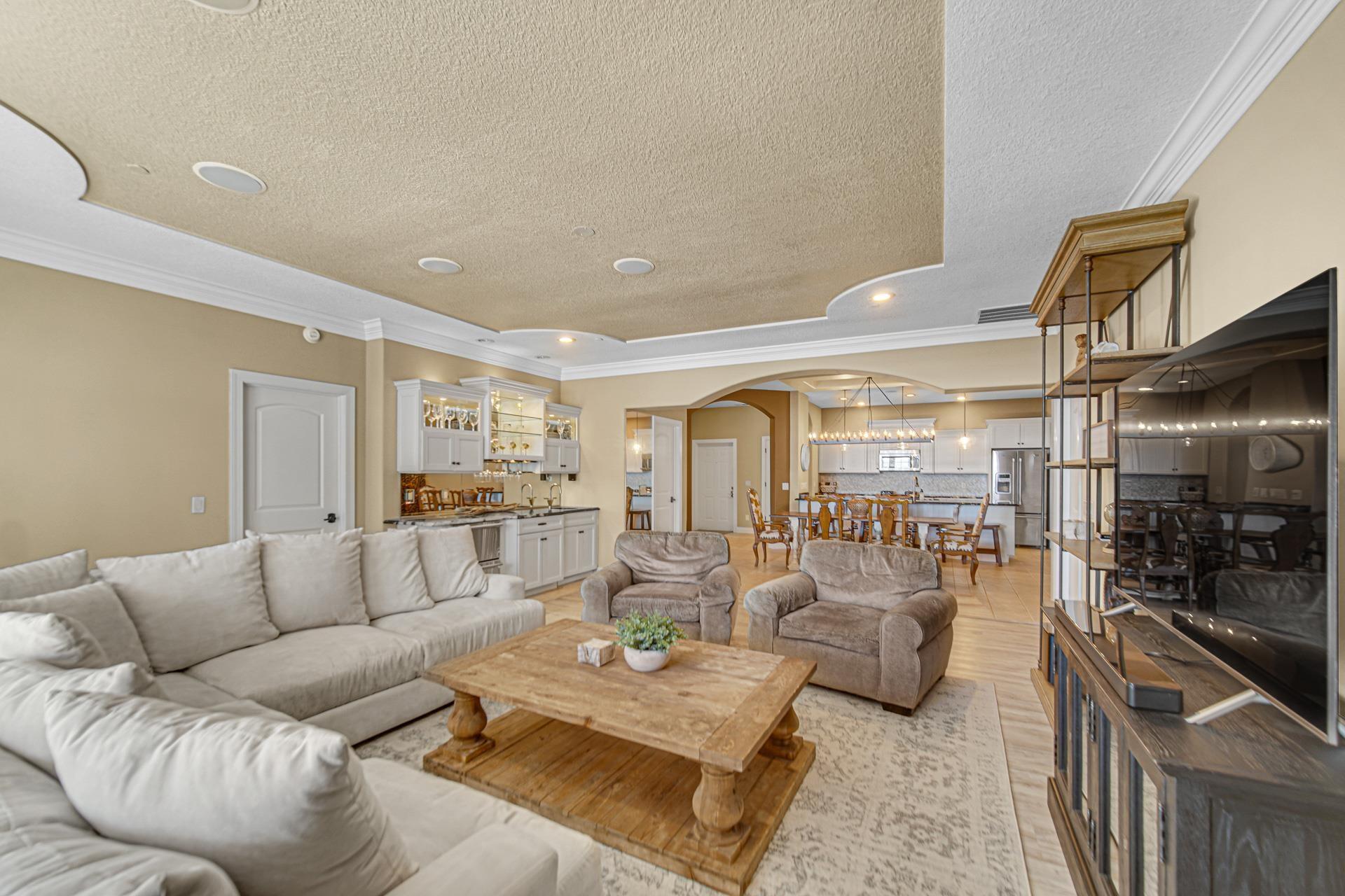 Image 3: Living room featuring crown molding, arched walkways, a textured ceiling, light wood-type flooring, and recessed lighting, Living Room Image 3: Living room featuring crown molding, arched walkways, a textured ceiling, light wood-type flooring, and recessed lighting, Living Room
