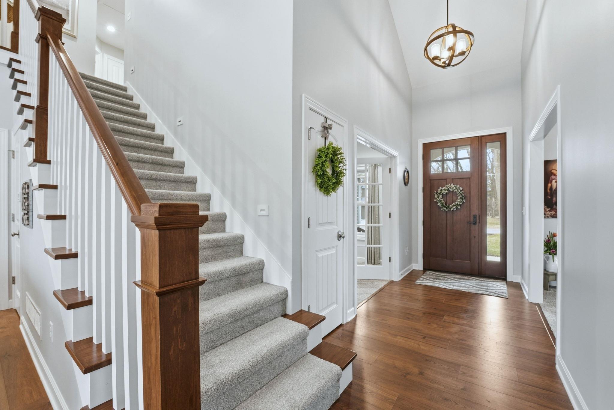 Image 1: Entryway featuring hardwood / wood-style flooring, a chandelier, and vaulted ceiling, Entrance Foyer