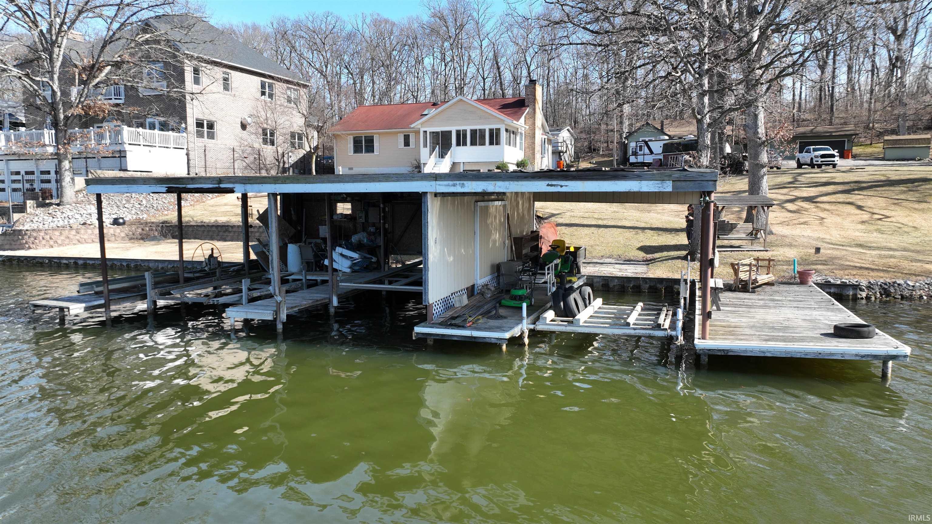 Image 3: Dock featuring boat lift and a water view, Dock