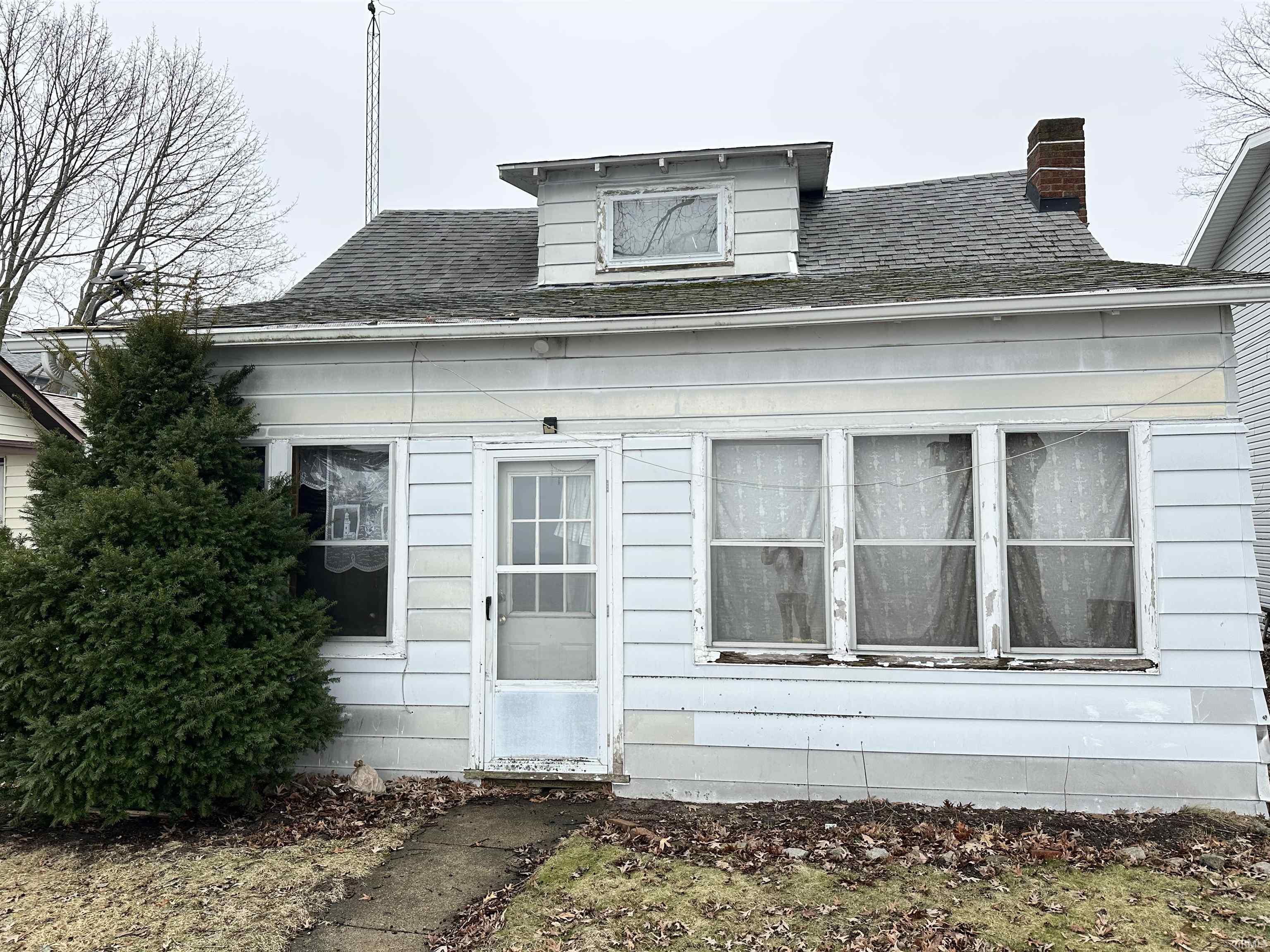 Image 0: View of side of home with roof with shingles and a chimney, Side Of Structure