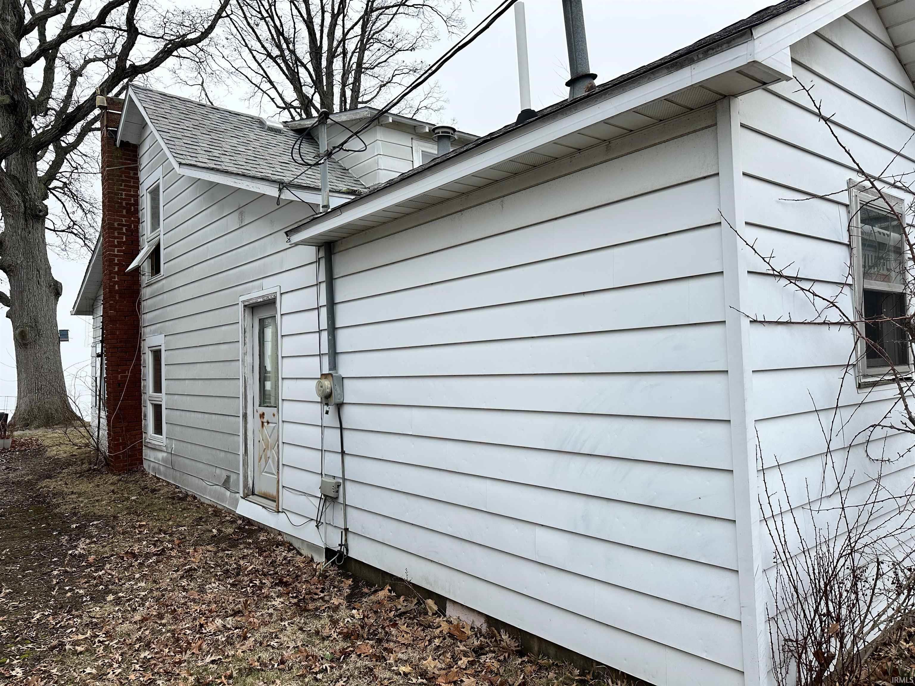 Image 2: View of side of home featuring a shingled roof, Side Of Structure