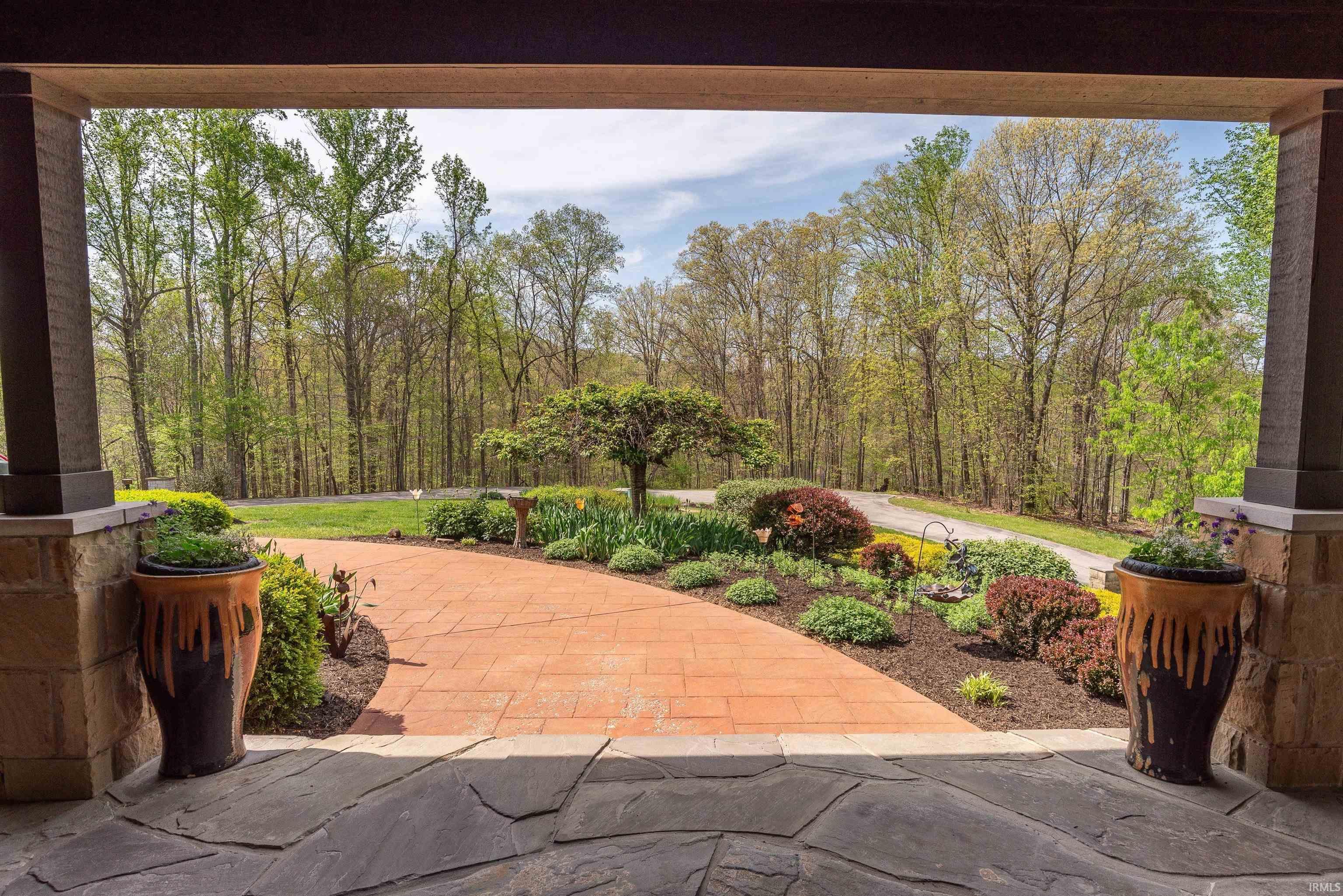 Image 3: Covered stone patio featuring stone columns with wood-finish beams, Front Porch Image 3: Covered stone patio featuring stone columns with wood-finish beams, Front Porch