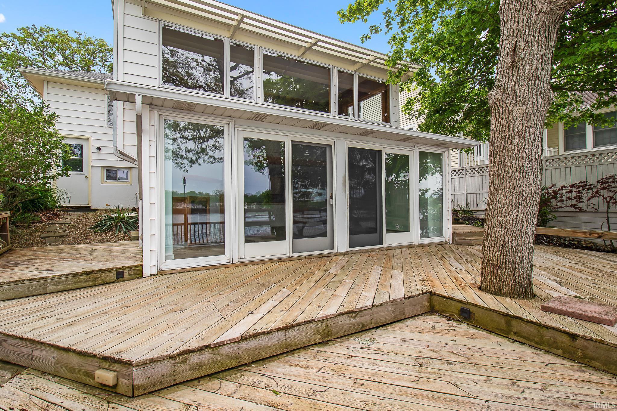 Image 1: Multi-level wood deck featuring a mature tree integration, Deck Image 1: Multi-level wood deck featuring a mature tree integration, Deck
