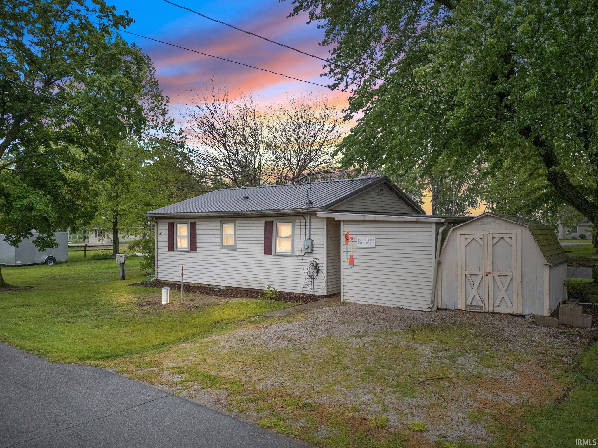 Image 0: White vinyl siding home with a metal roof, Front Of Structure Image 0: White vinyl siding home with a metal roof, Front Of Structure