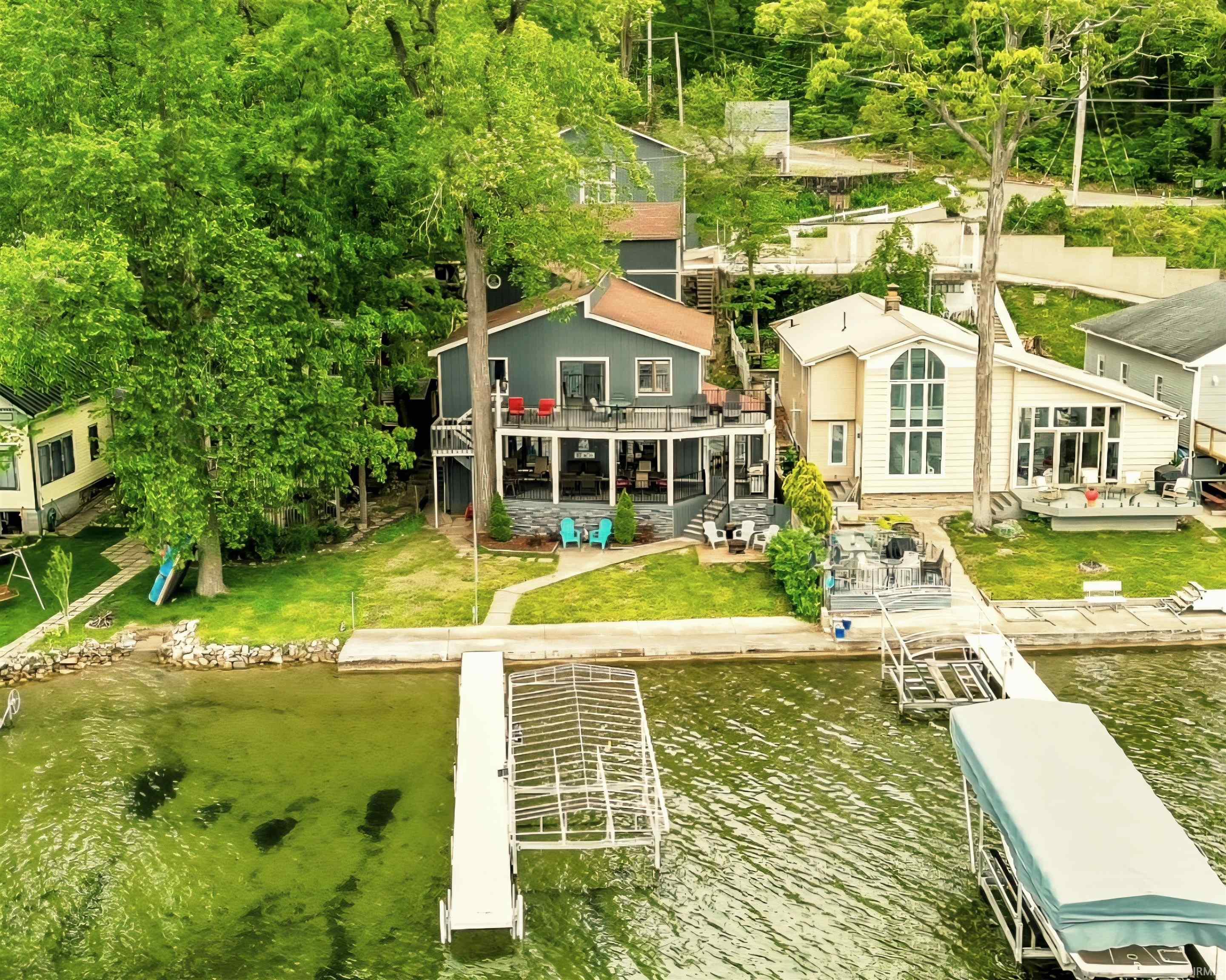 Image 1: Waterfront residence featuring a two-story deck, private dock, and an additional boat lift, Back Of Structure Image 1: Waterfront residence featuring a two-story deck, private dock, and an additional boat lift, Back Of Structure