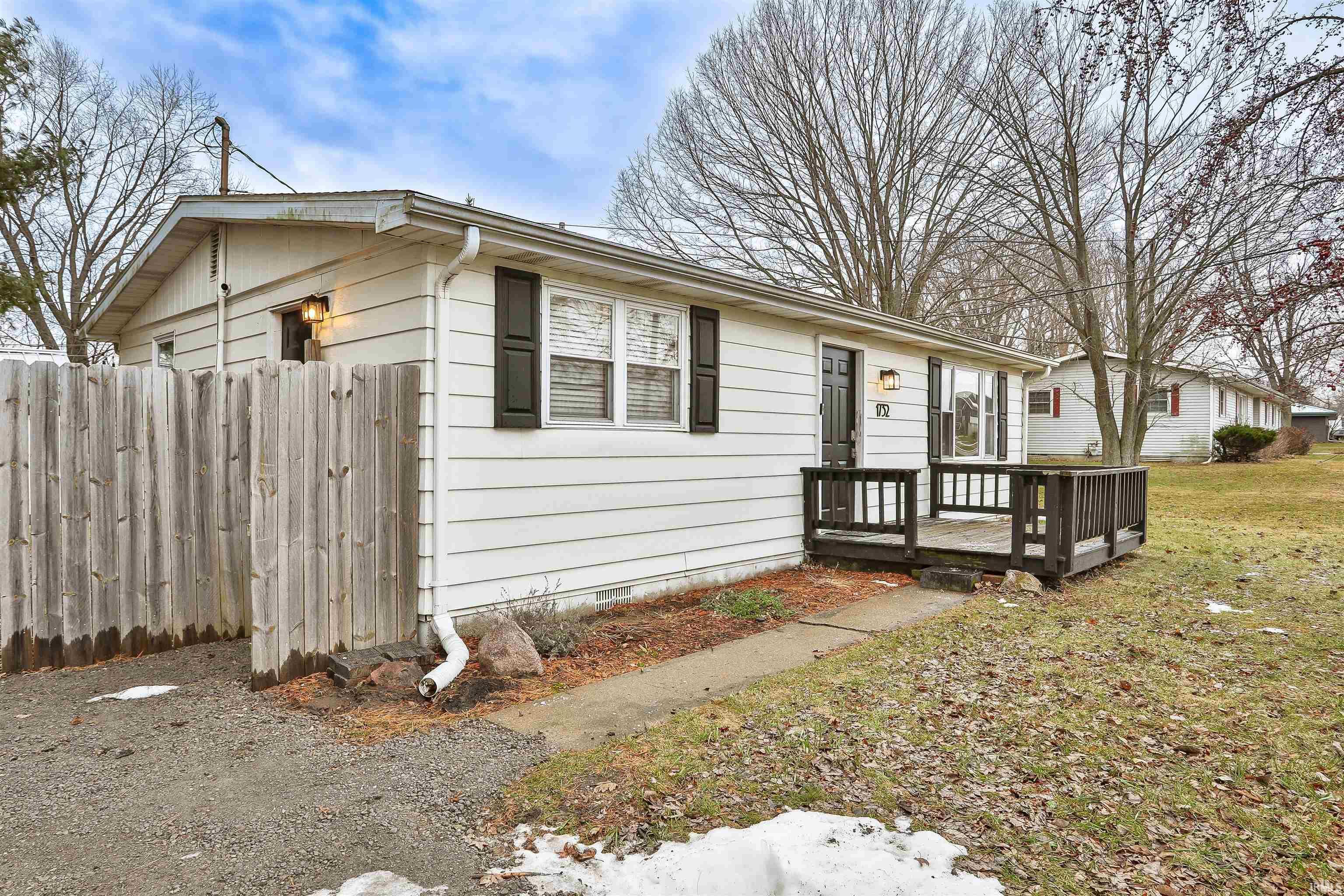 Image 1: View of property exterior featuring crawl space and a wooden deck, Side Of Structure Image 1: View of property exterior featuring crawl space and a wooden deck, Side Of Structure