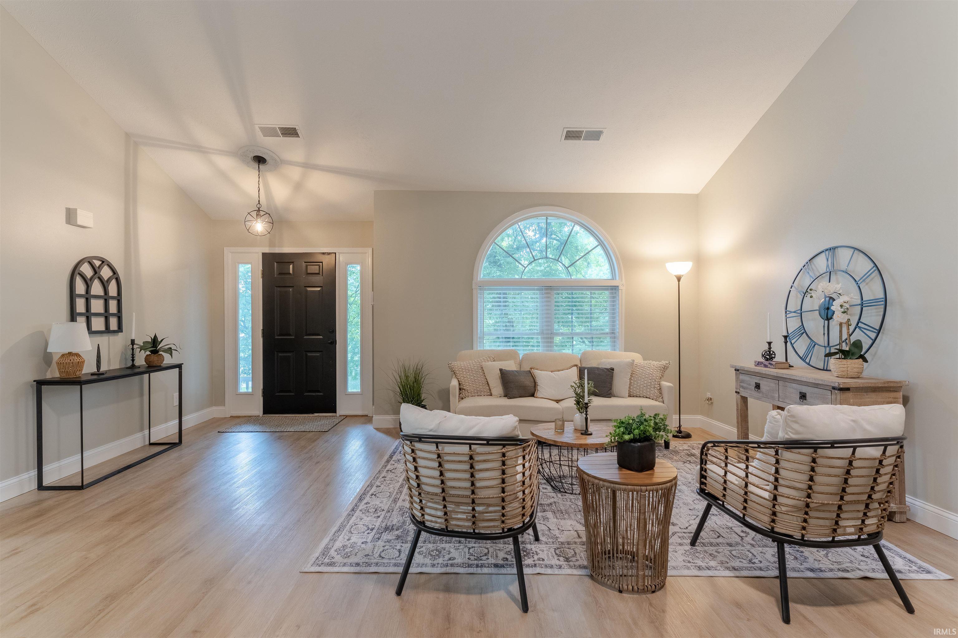 Image 1: Living area with lofted ceiling and light wood finished floors, Living Room