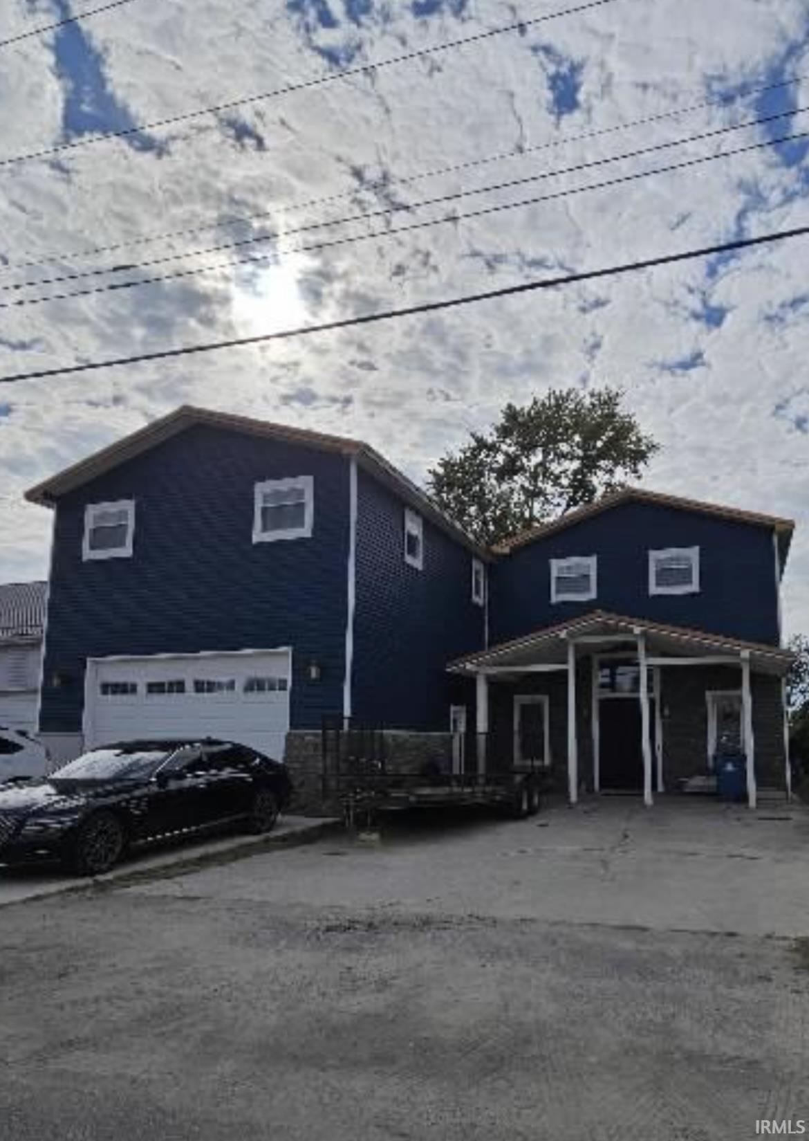 Image 0: View of building exterior with a garage, Front Of Structure
