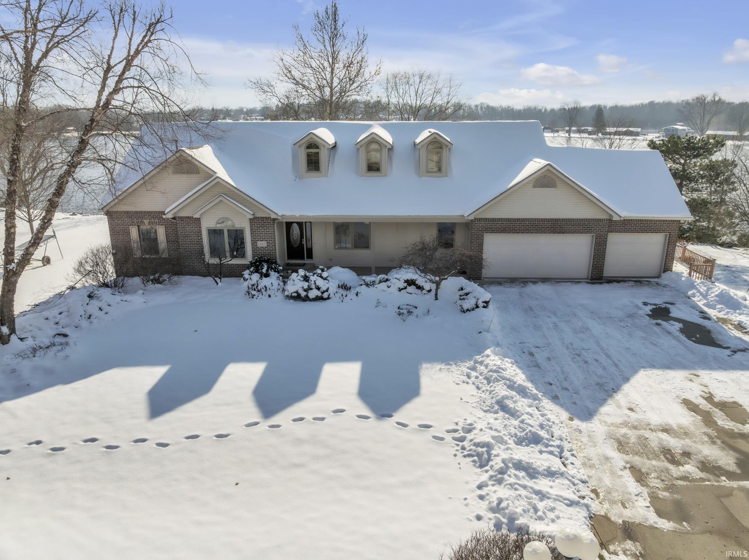 Image 0: Cape cod home with brick siding and a garage, Front Of Structure