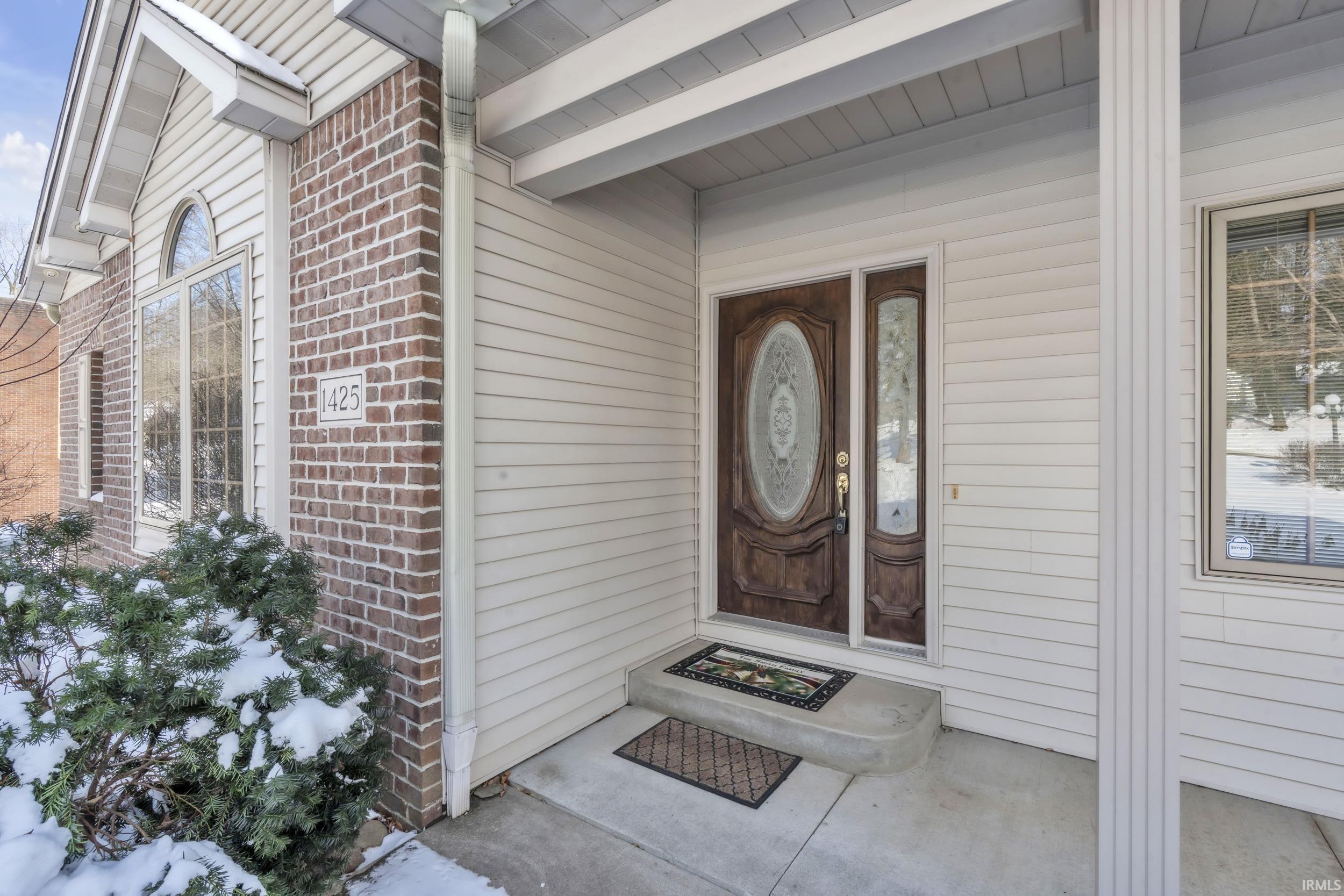 Image 1: Property entrance with brick siding and a porch, Entry