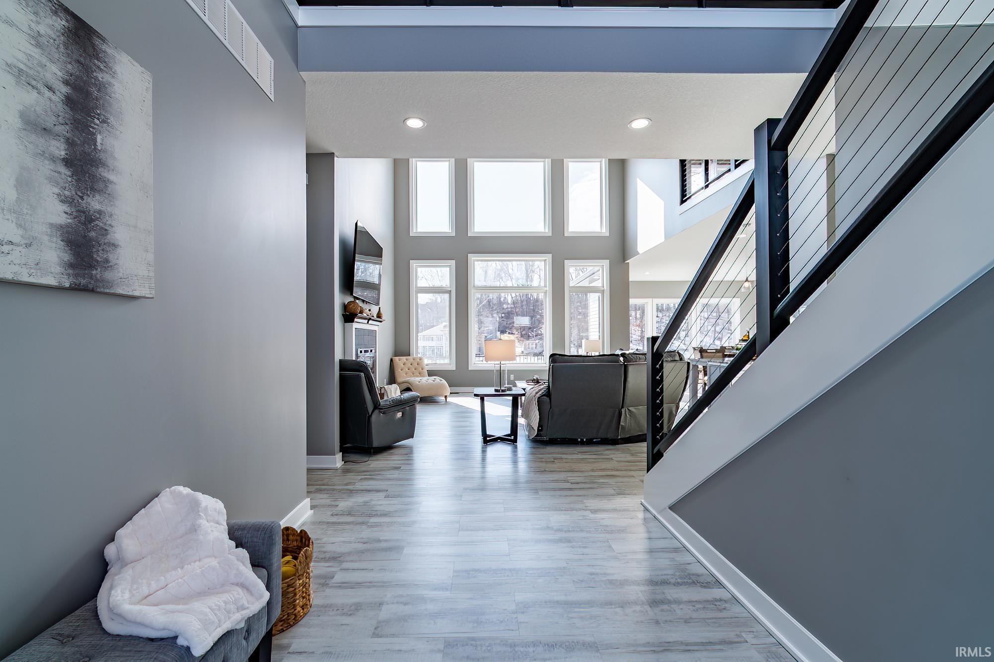 Image 2: Corridor with a high ceiling, recessed lighting, and light wood finished floors, Hallway
