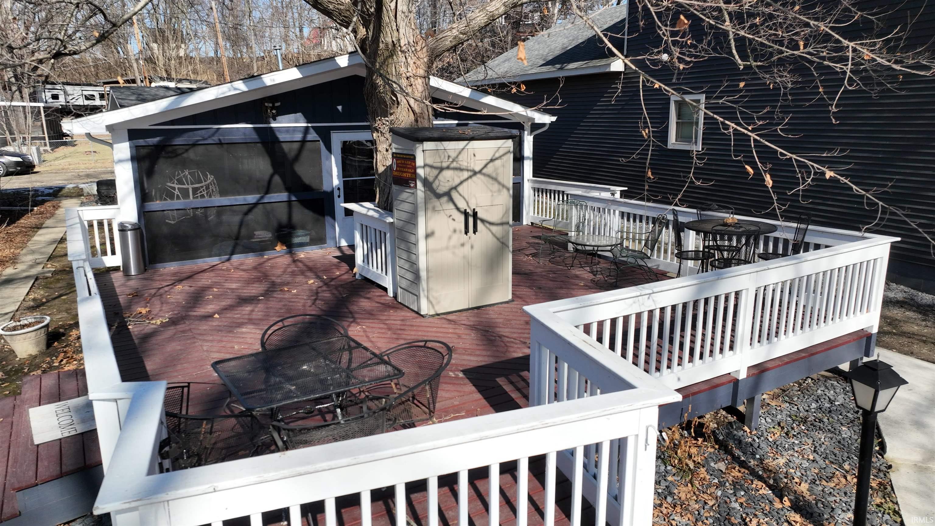 Image 1: Wooden deck featuring outdoor dining space, Deck