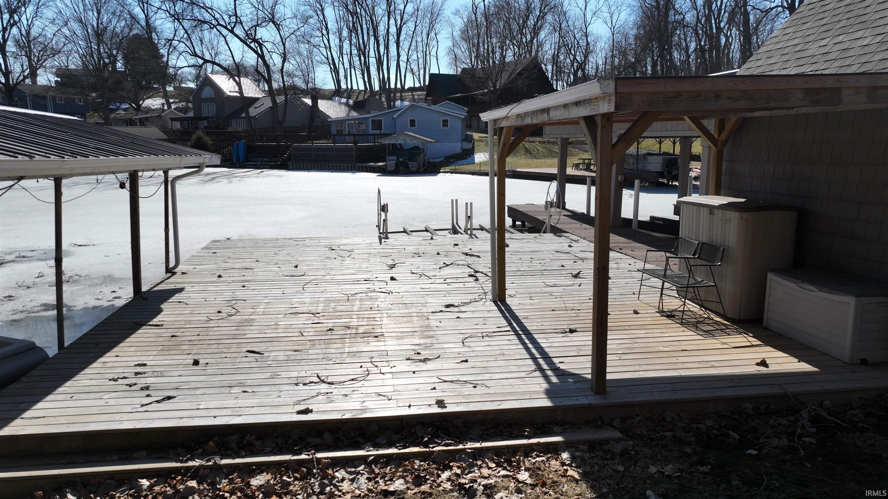 Image 4: Dock area with a gazebo, boat lift, and a residential view, Dock