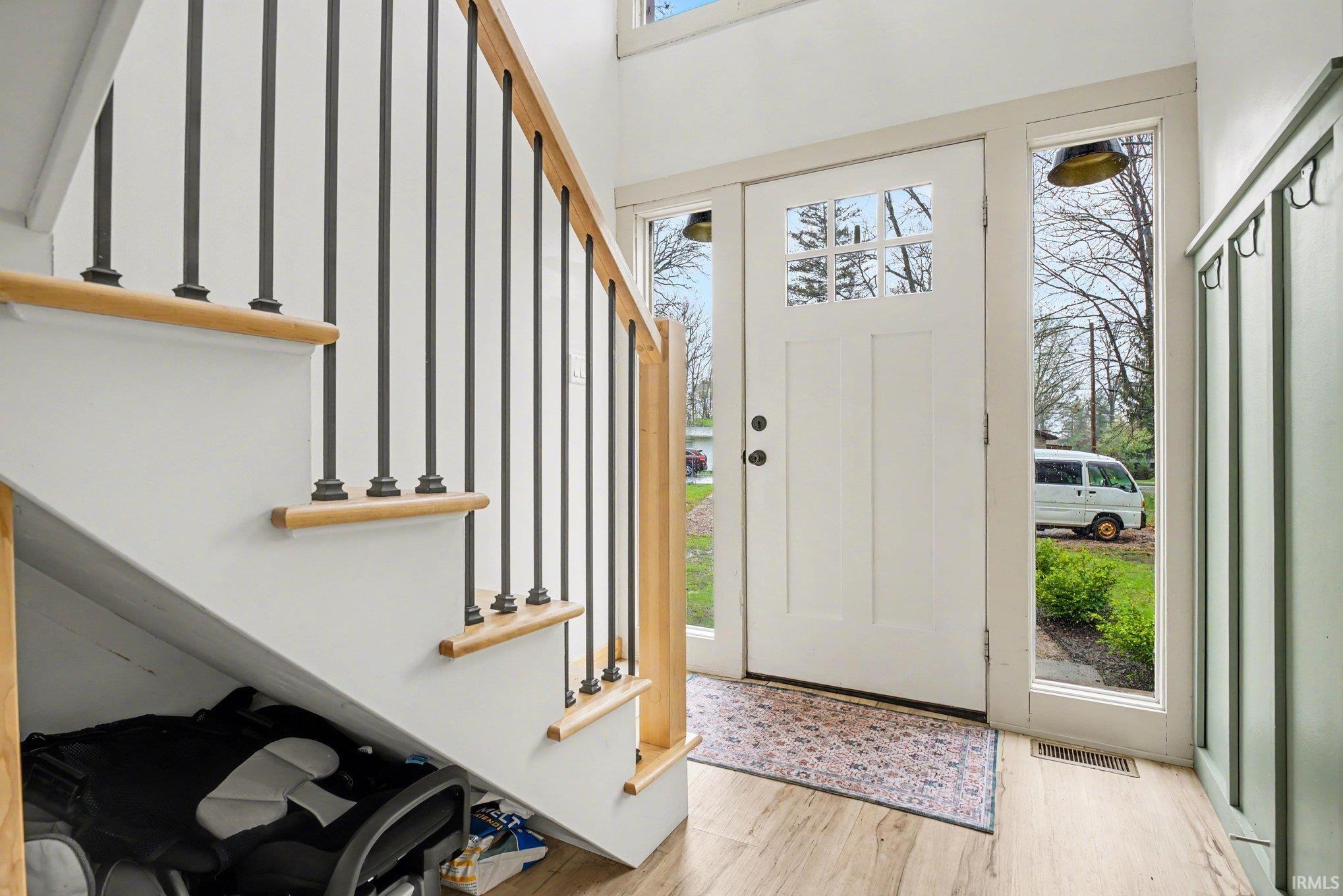 Image 2: Entrance foyer featuring stairs and light wood flooring, Entrance Foyer