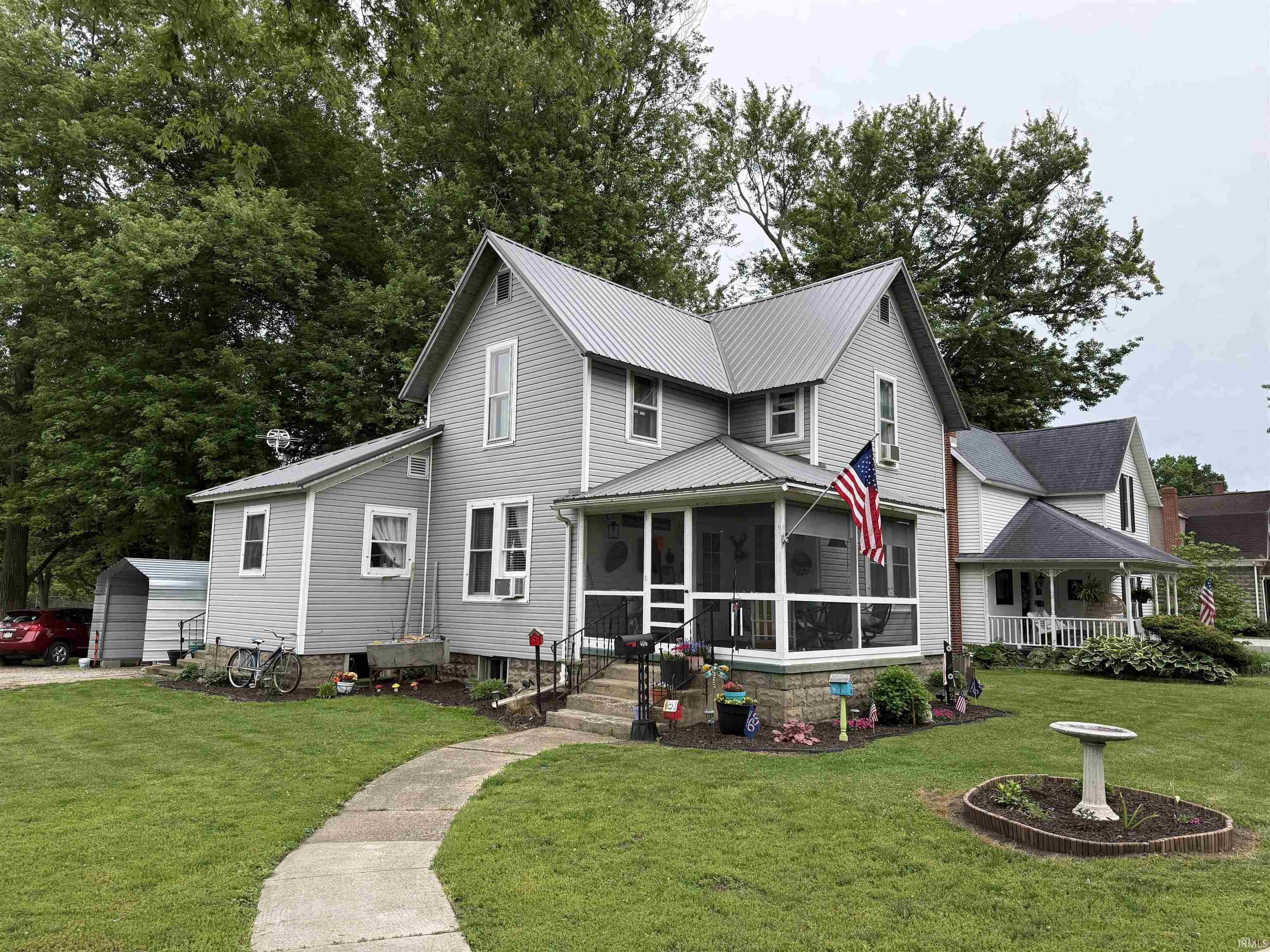 Image 0: Gray two-story residence featuring a screened-in front porch with white railings, Front Of Structure Image 0: Gray two-story residence featuring a screened-in front porch with white railings, Front Of Structure