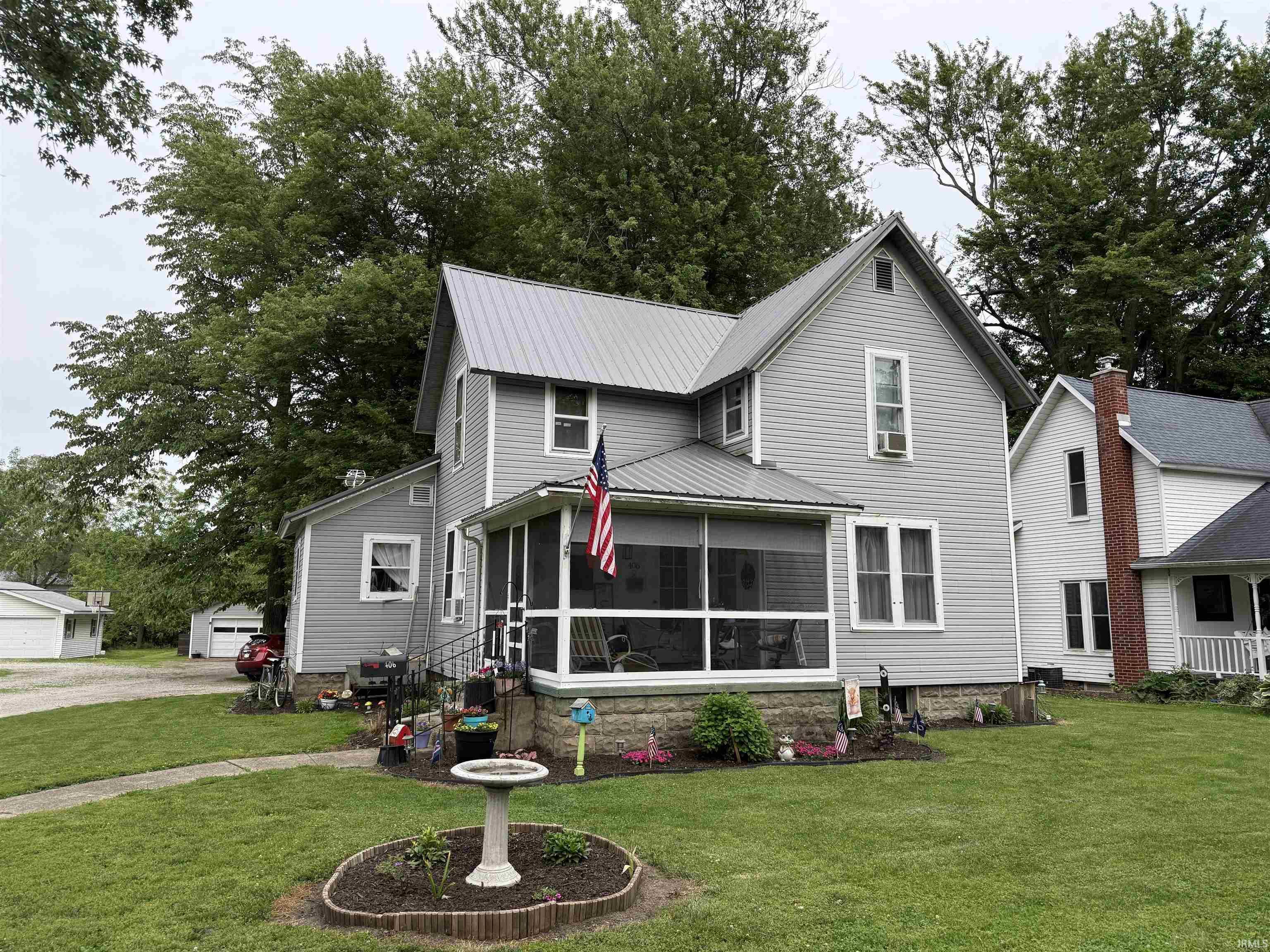 Image 1: Gray siding exterior with a metal roof, Front Of Structure Image 1: Gray siding exterior with a metal roof, Front Of Structure