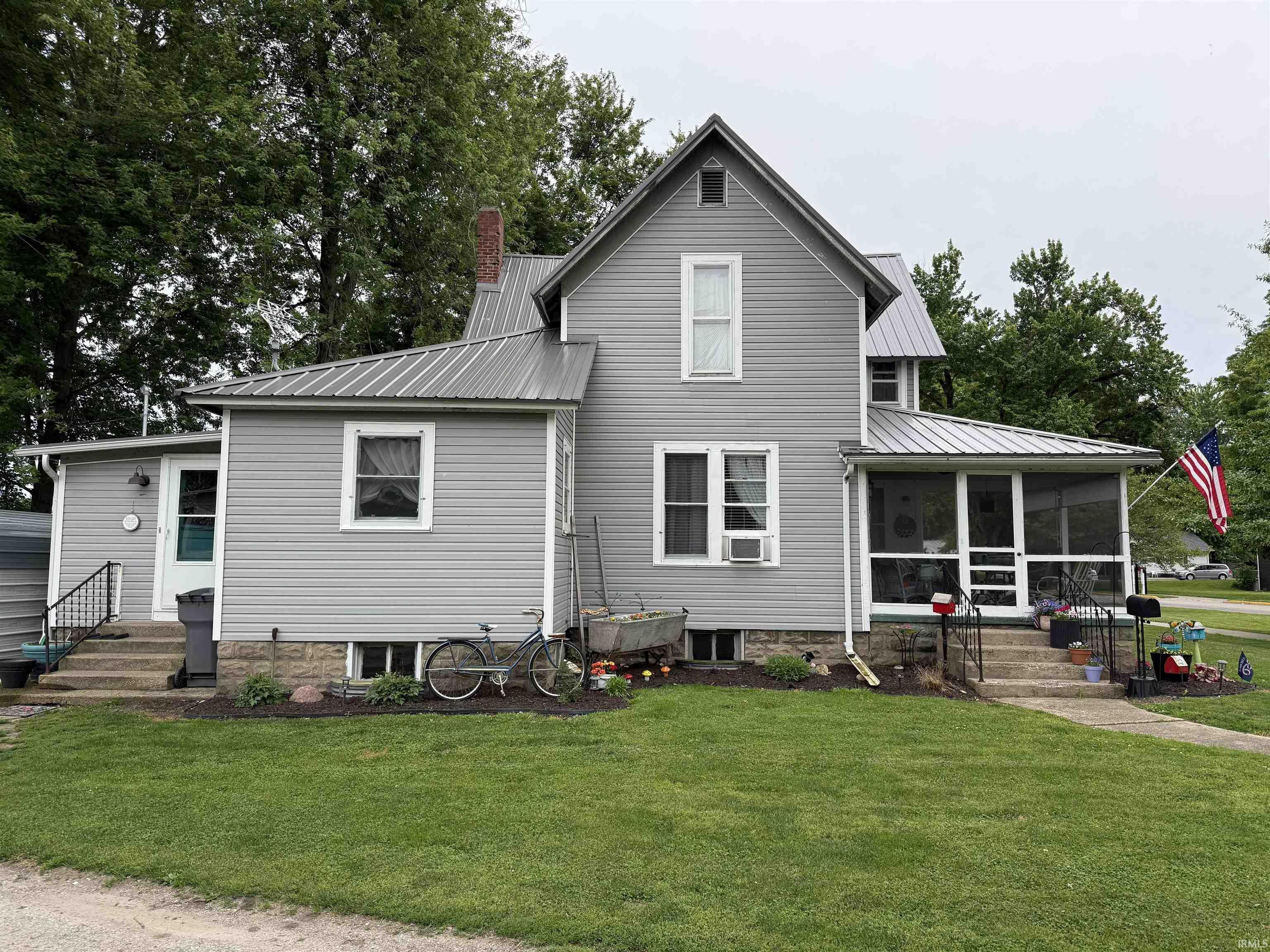 Image 3: Gray siding exterior with a metal roof and a screened porch, Front Of Structure Image 3: Gray siding exterior with a metal roof and a screened porch, Front Of Structure