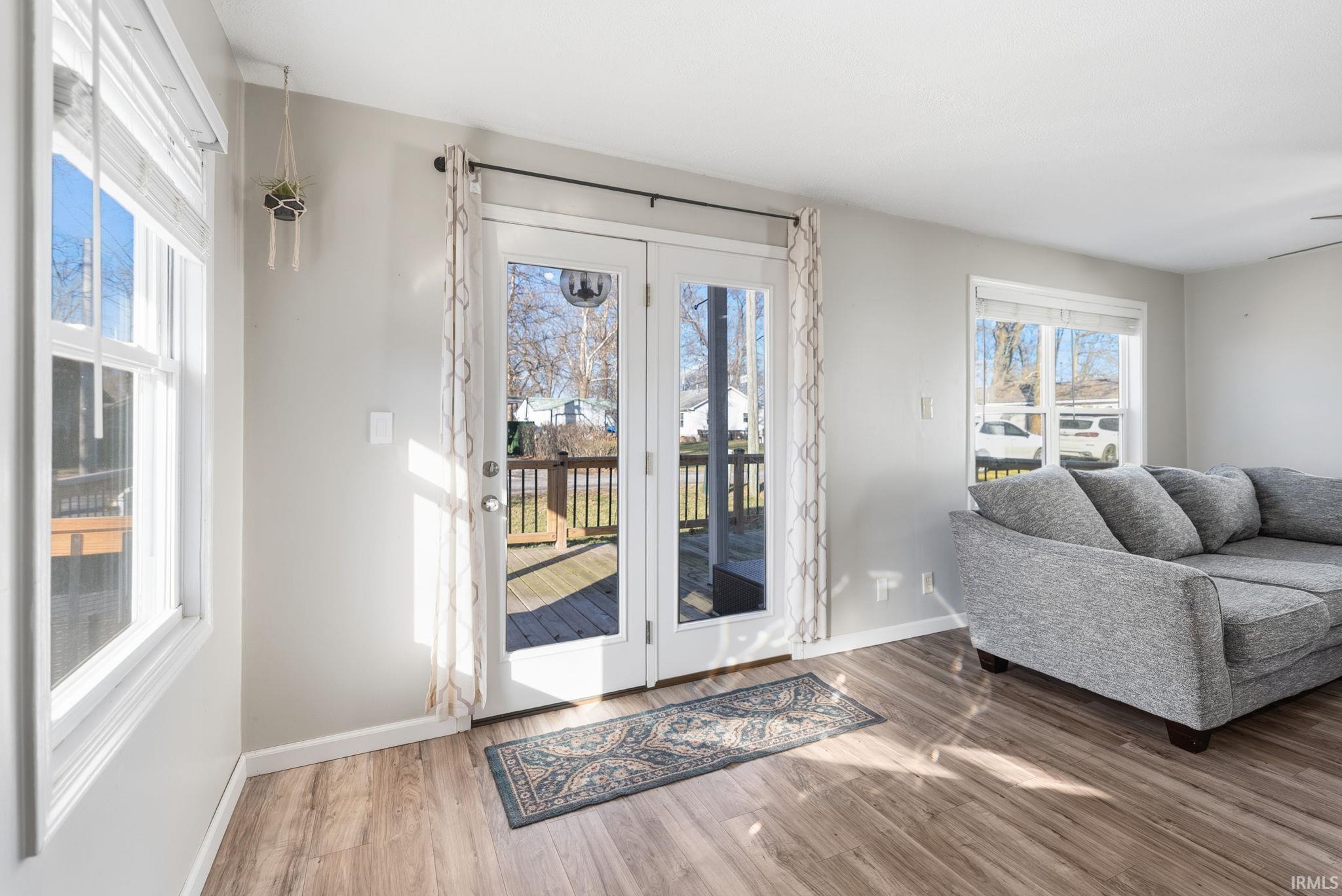 Image 3: Doorway to outside featuring baseboards and wood finished floors, Entry