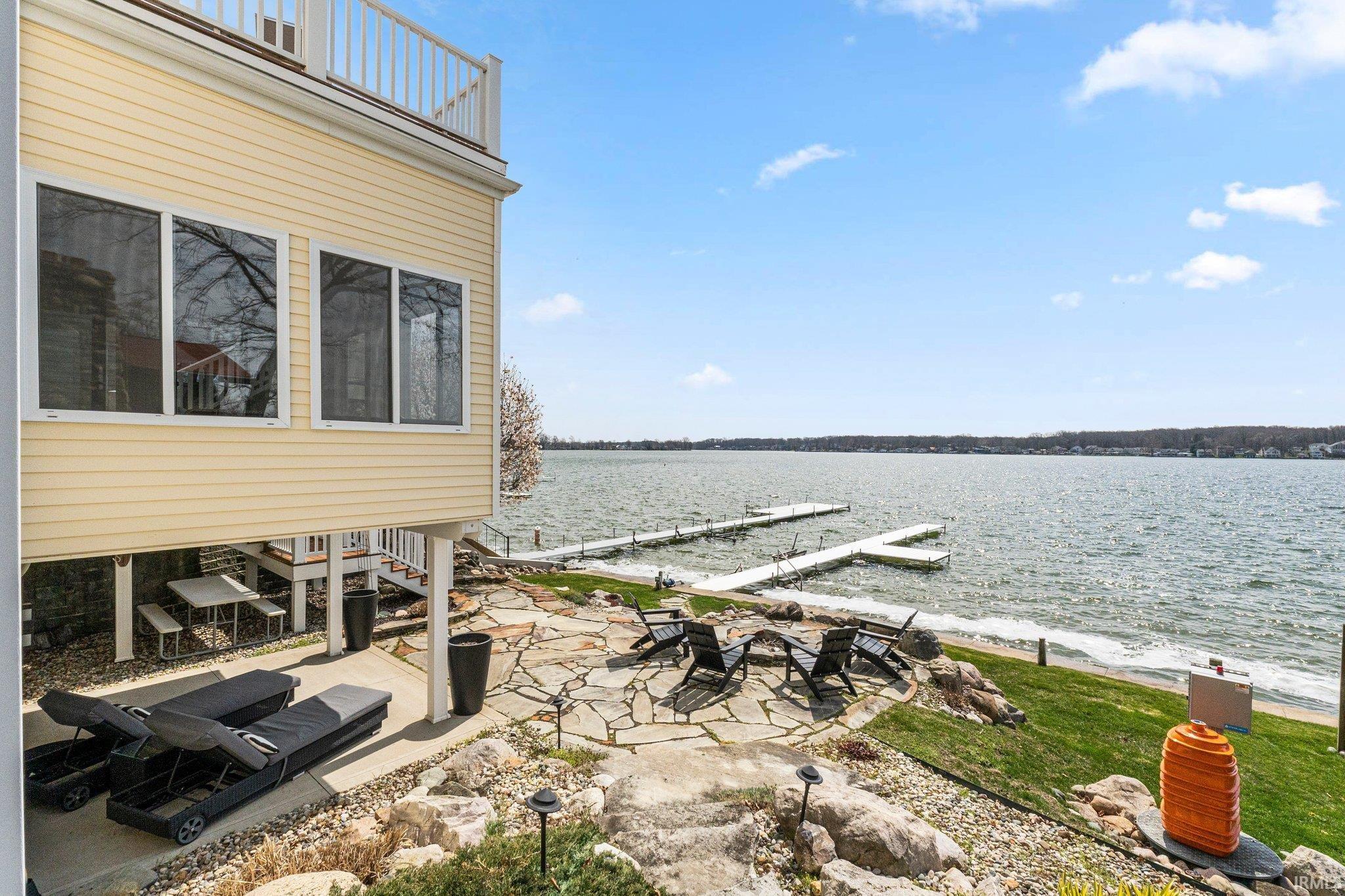 Image 2: View of patio featuring a boat dock, a water view, and a fire pit, Patio