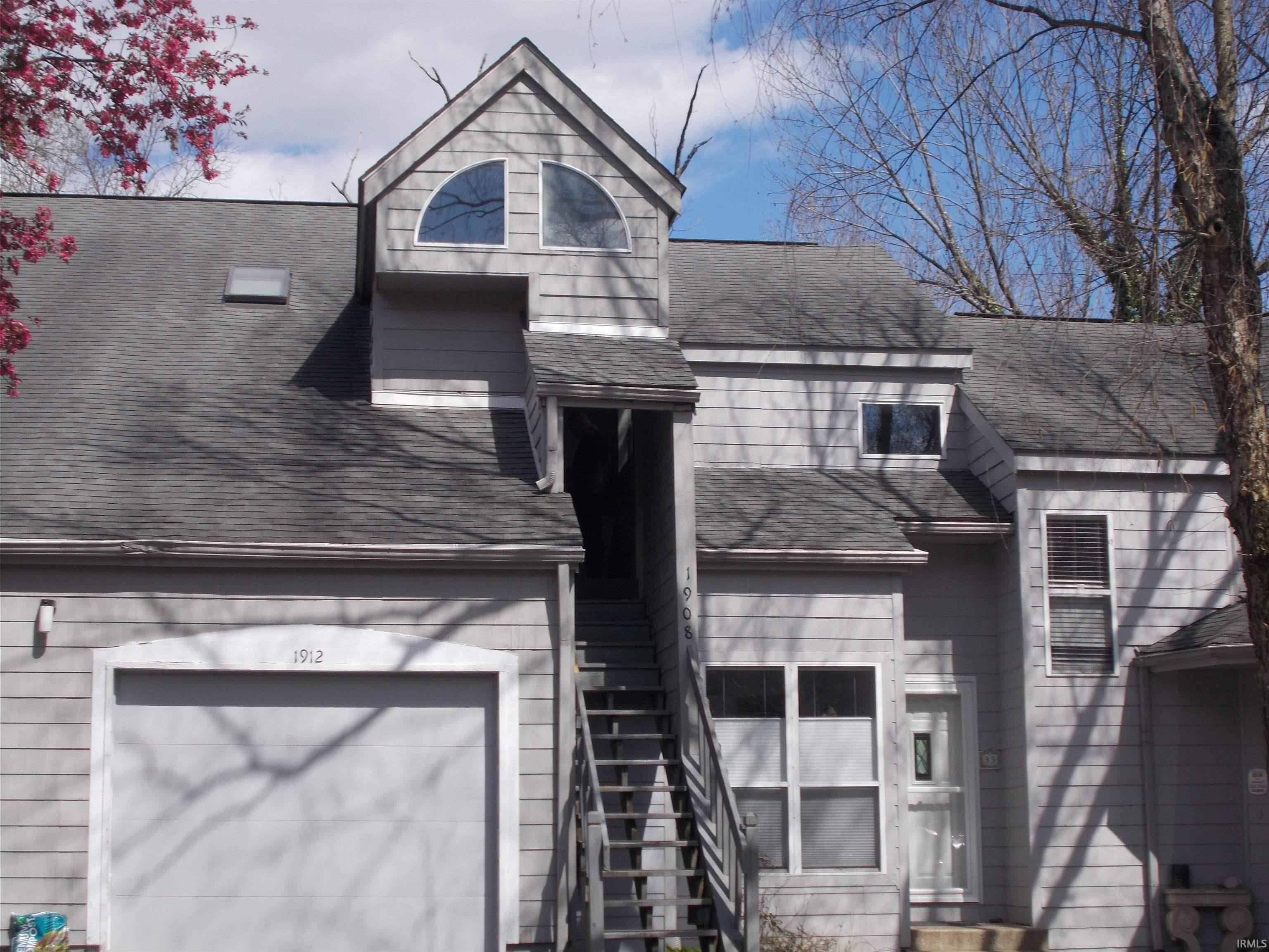 Image 0: View of front of house with a shingled roof and a garage, Front Of Structure