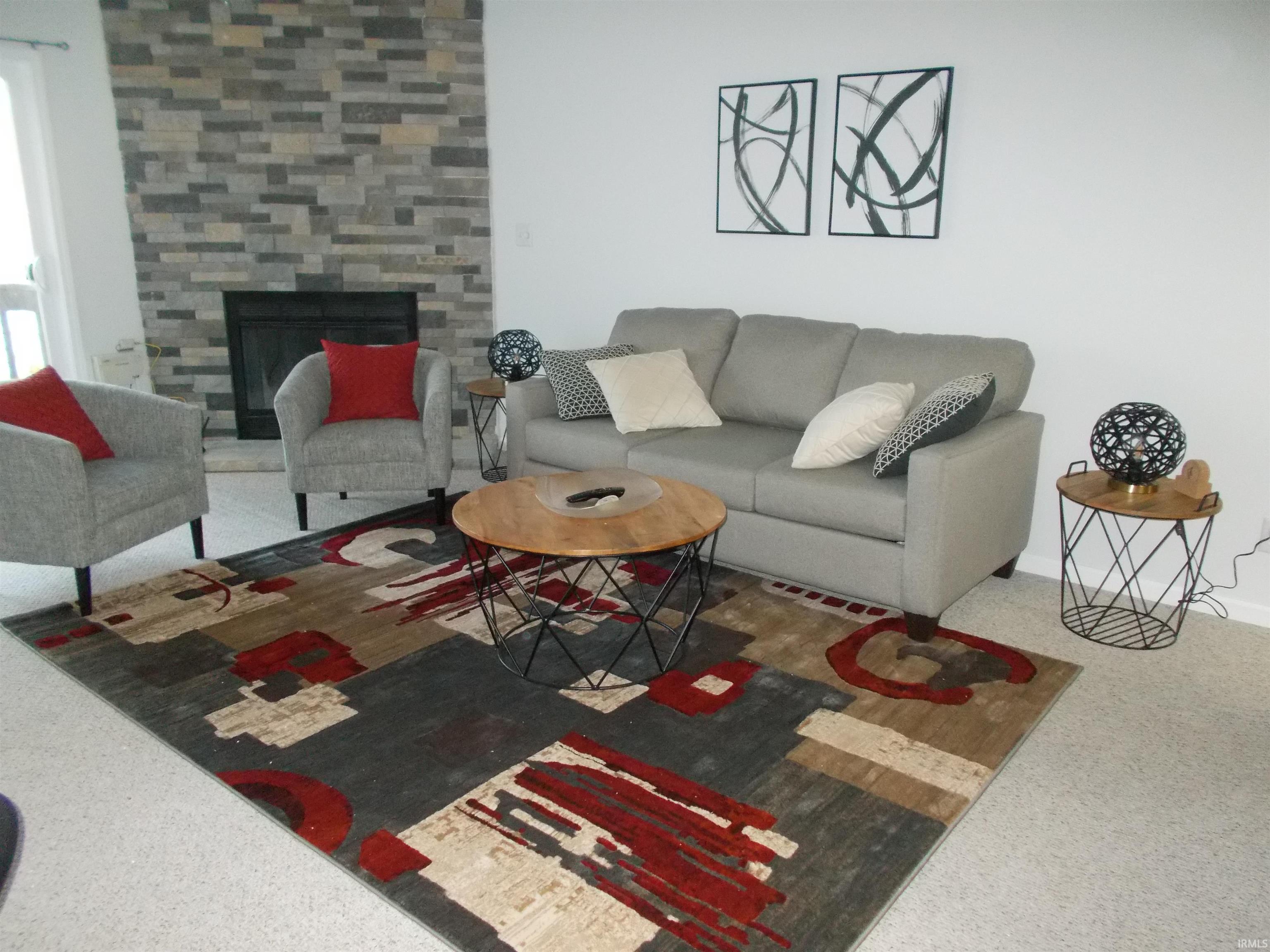 Image 2: Carpeted living room with a tiled fireplace, Living Room