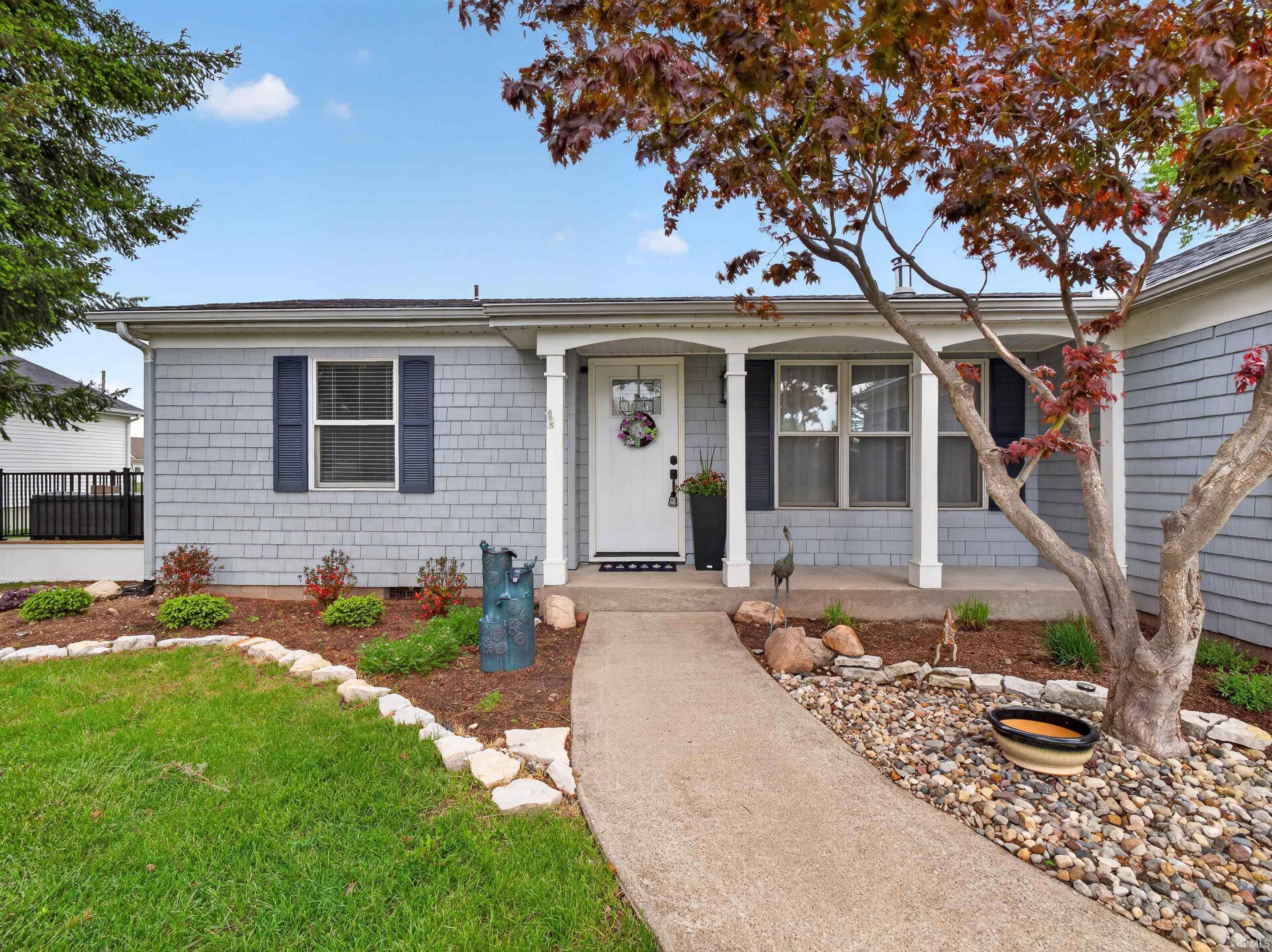 Image 3: Front exterior with light gray shake siding and a covered entry, Front Of Structure Image 3: Front exterior with light gray shake siding and a covered entry, Front Of Structure