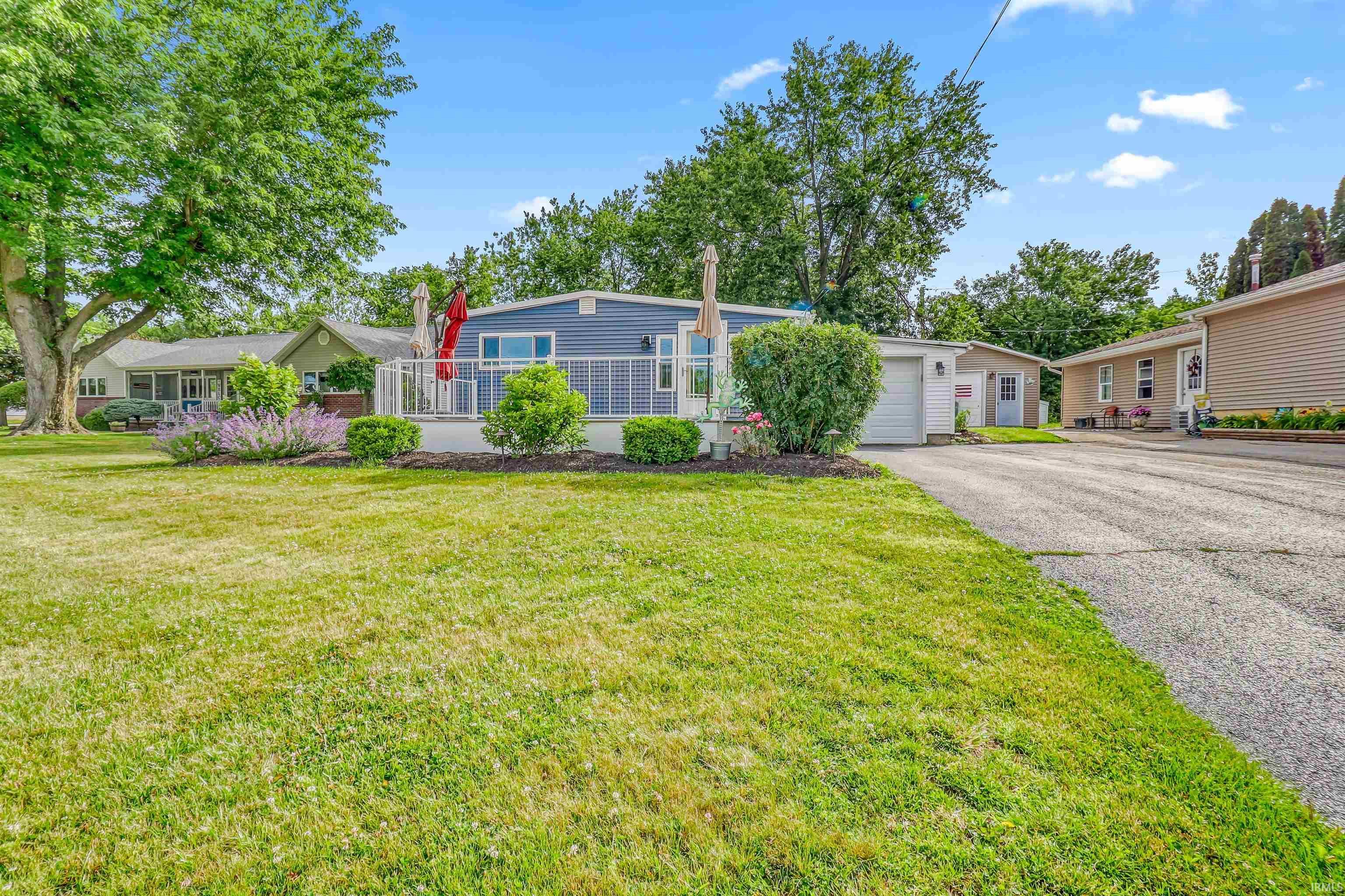 Image 2: Spacious front yard with mature trees and a manicured lawn, Front Of Structure Image 2: Spacious front yard with mature trees and a manicured lawn, Front Of Structure