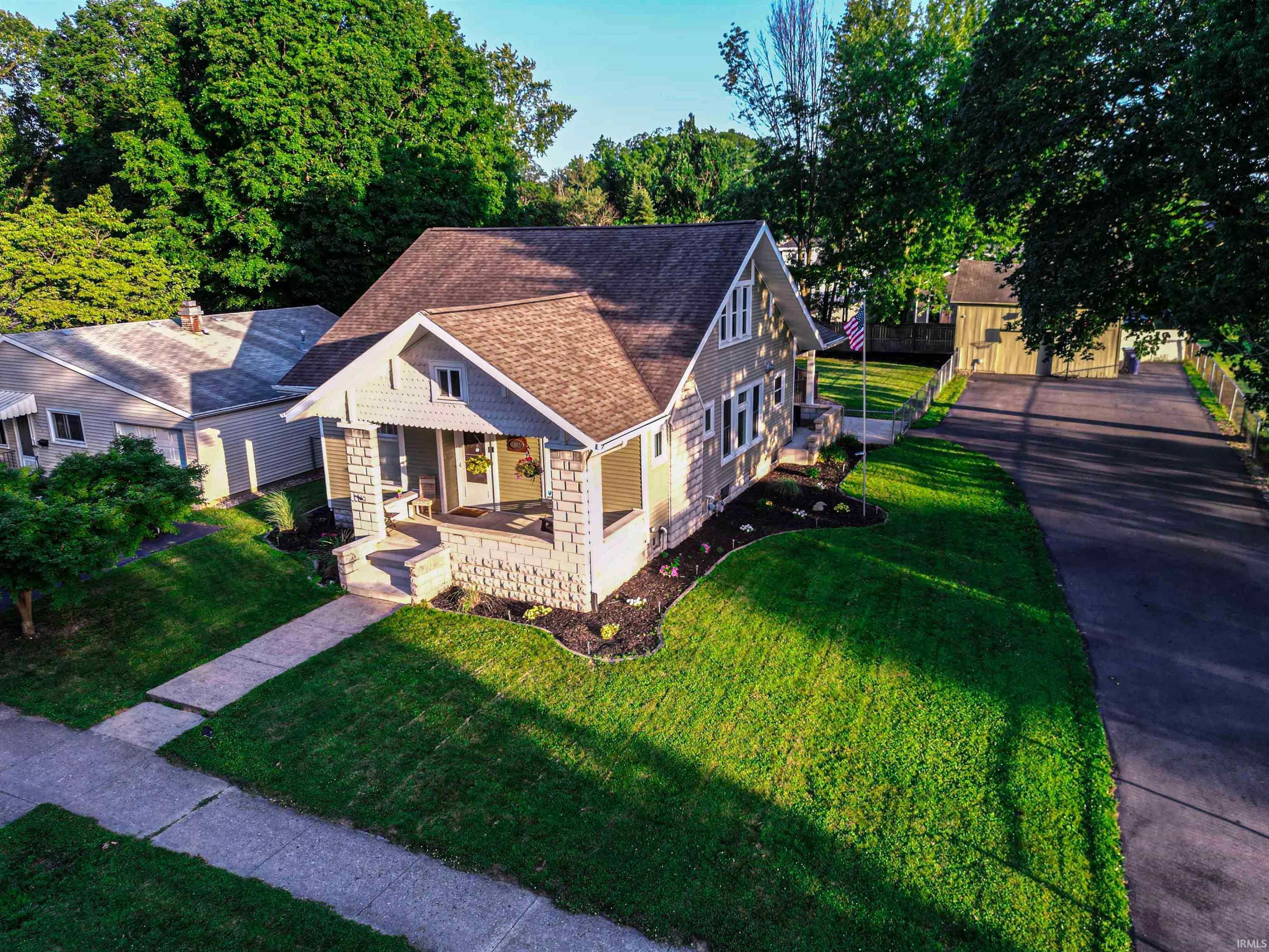 Image 0: Front house, long paved driveway