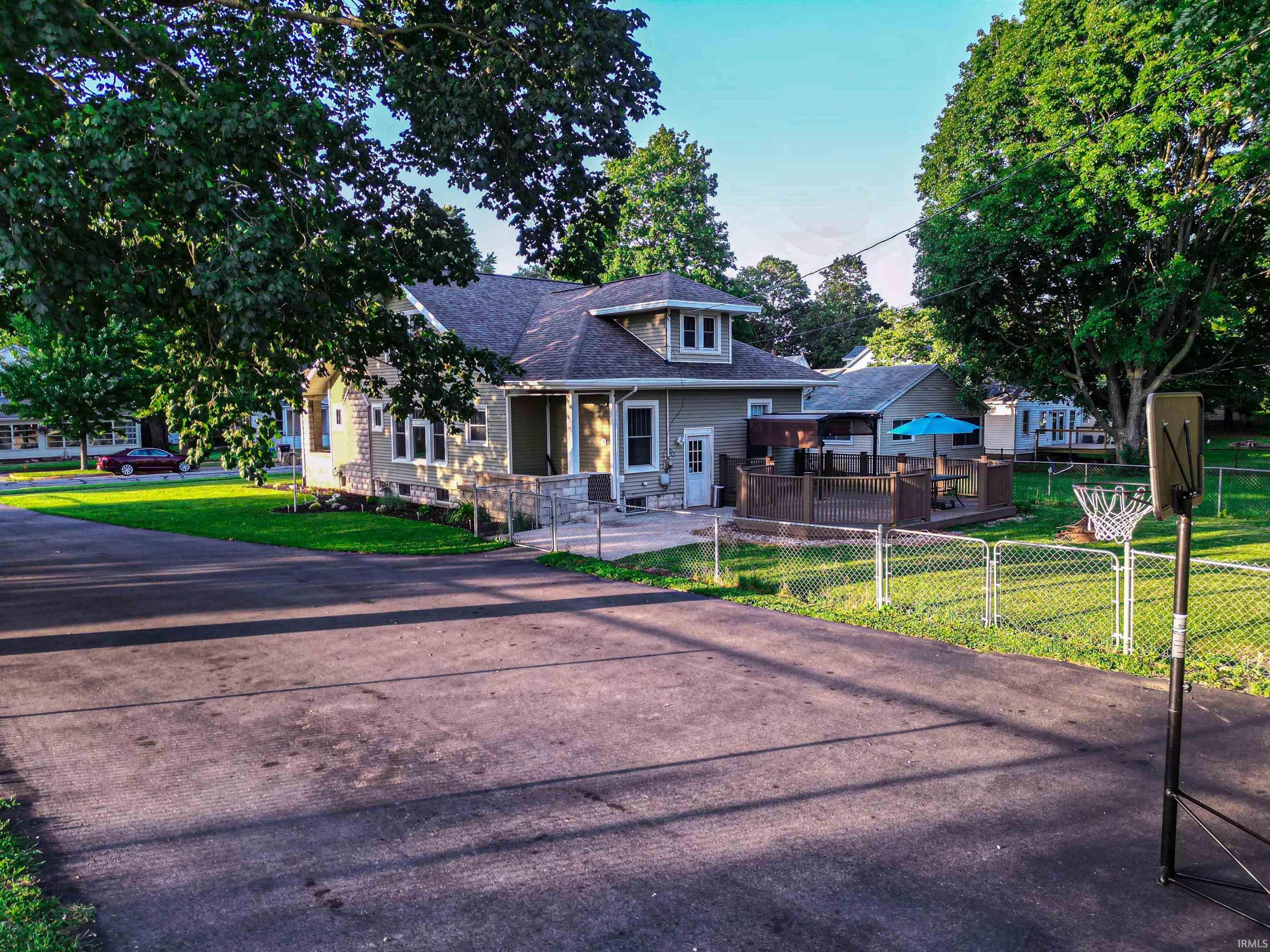 Image 2: Exterior featuring a neutral-toned facade with stone accents, multiple windows, and a covered front porch, Front Of Structure