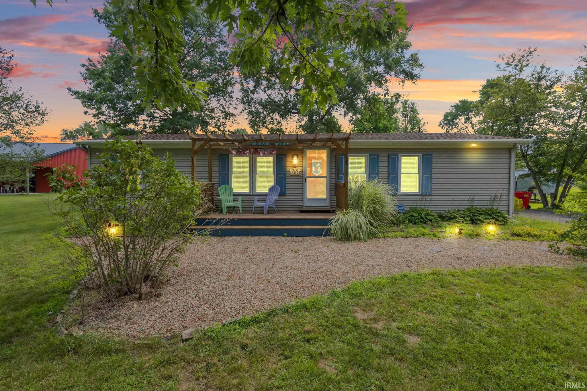 Image 0: Single story home featuring a deck and a front yard, Front Of Structure Image 0: Single story home featuring a deck and a front yard, Front Of Structure