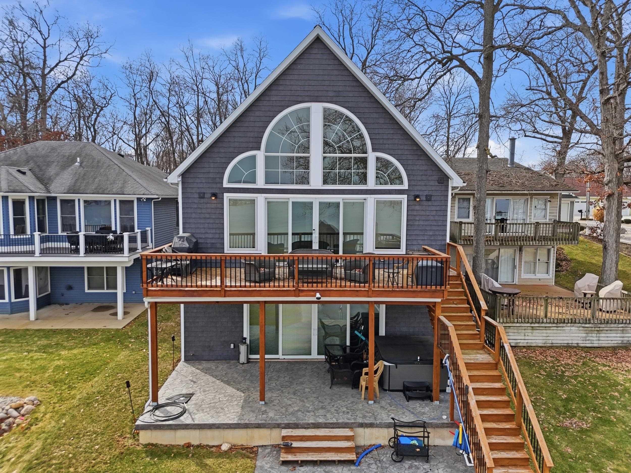 Image 0: Rear view of property featuring a deck, a patio area, a yard, and a hot tub, Back Of Structure Image 0: Rear view of property featuring a deck, a patio area, a yard, and a hot tub, Back Of Structure