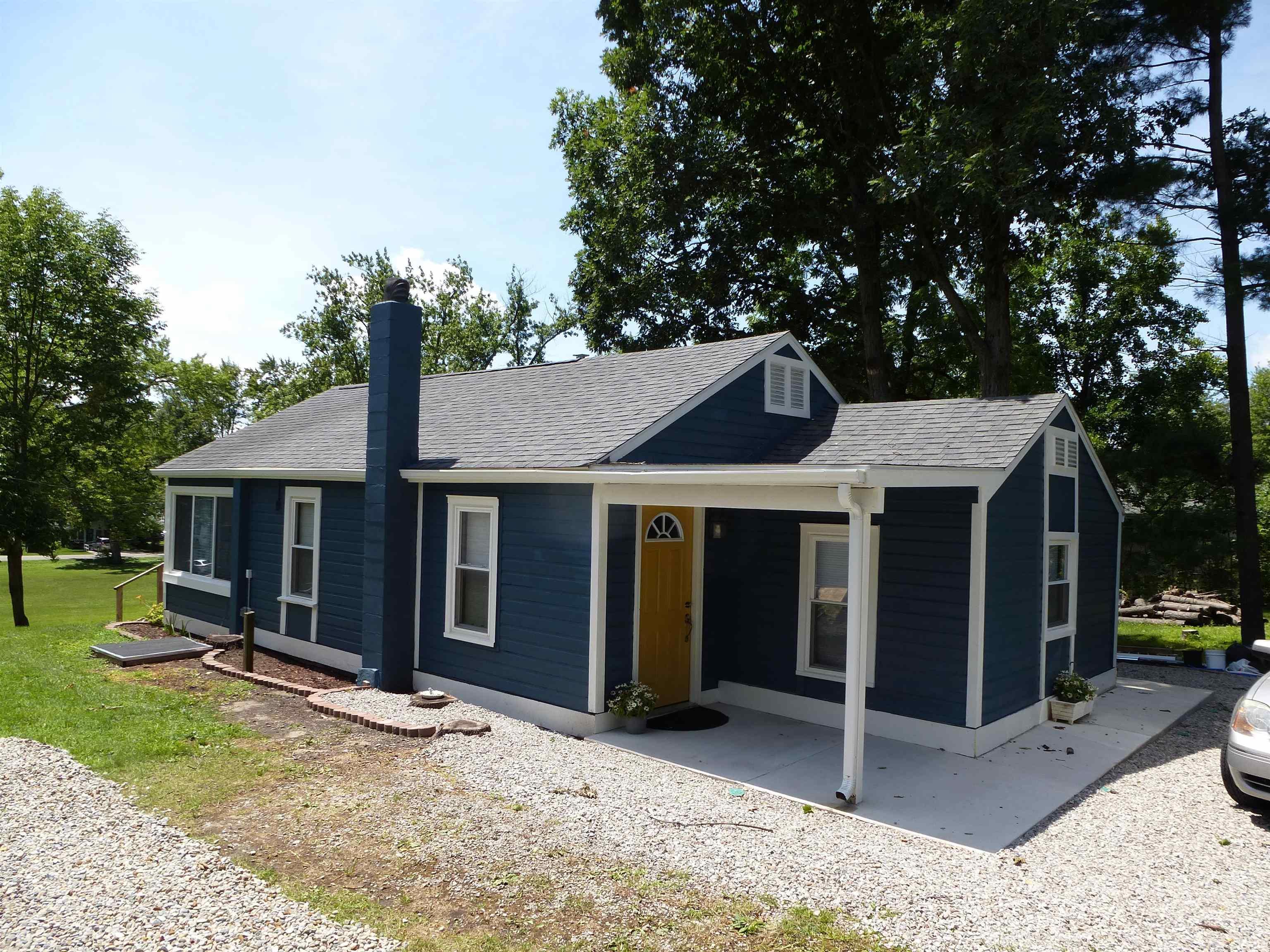 Image 0: View of front of home featuring a shingled roof and a chimney, Front Of Structure